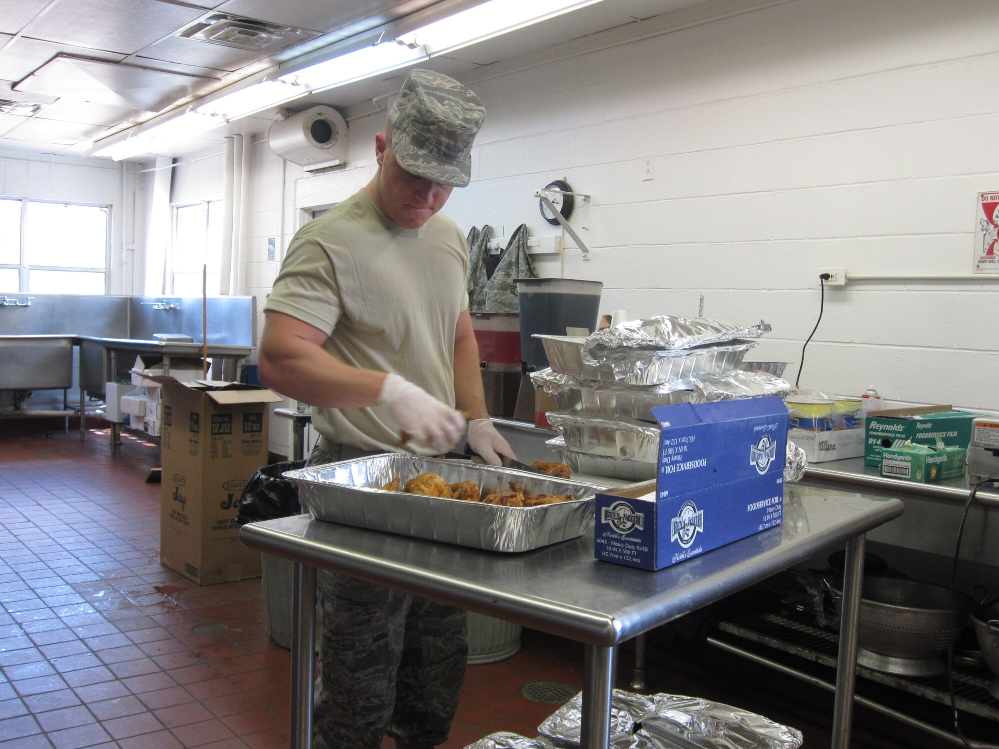 An Air Force reservist the 442nd Services Flight prepares food during the Patriot Defender Ground Combat Skills training exercise at Fort Wolters, Texas.  For 15 days, services flight citizen Airmen provided breakfast and dinner to approximately 140 security forces Airmen preparing for overseas deployments.  (U.S. Air Force photo/Maj. Christina Marks) 