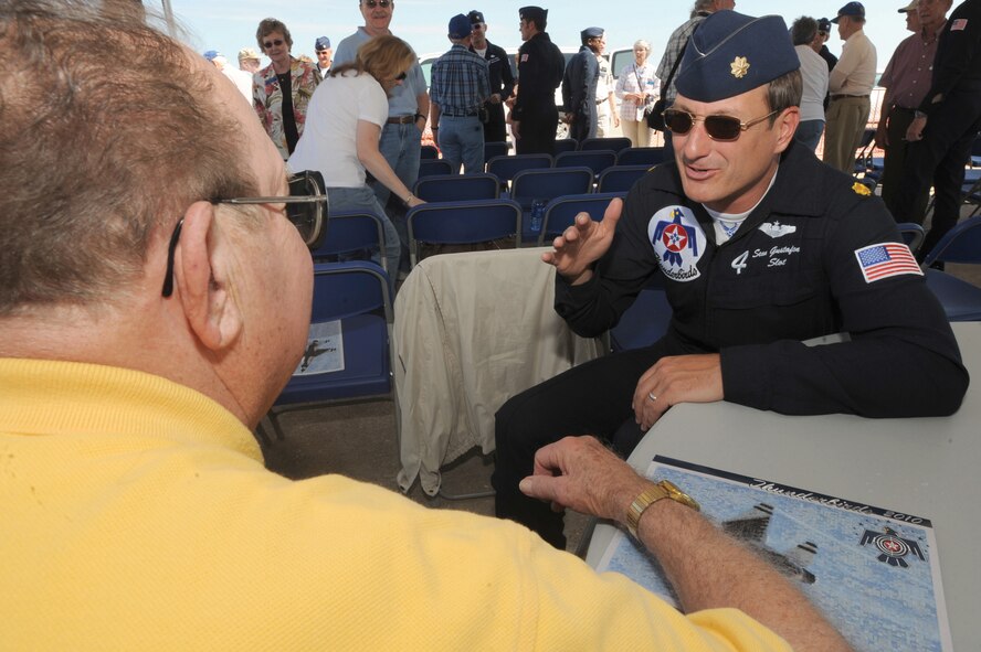Maj. Sean Gustafson, Air Force Thunderbird pilot, talks with an Air Force veteran at Whiteman Air Force Base, Mo., Sept. 17, following the Thunderbirds' rehearsal for the Wings Over Whiteman air show.  Major Gustafson is the first Air Force Reserve pilot to fly with the prestigious Thunderbirds aerial demonstration team, which visited Whiteman for a two-day air show Sept. 18 and 19.  Approximately 30 Air Force veterans and their families from the 39th Fighter Squadron Association were invited to watch the team's rehearsal and meet with the Thunderbirds' pilots.  (U.S. Air Force photo/Airman 1st Class Carlin Leslie) 