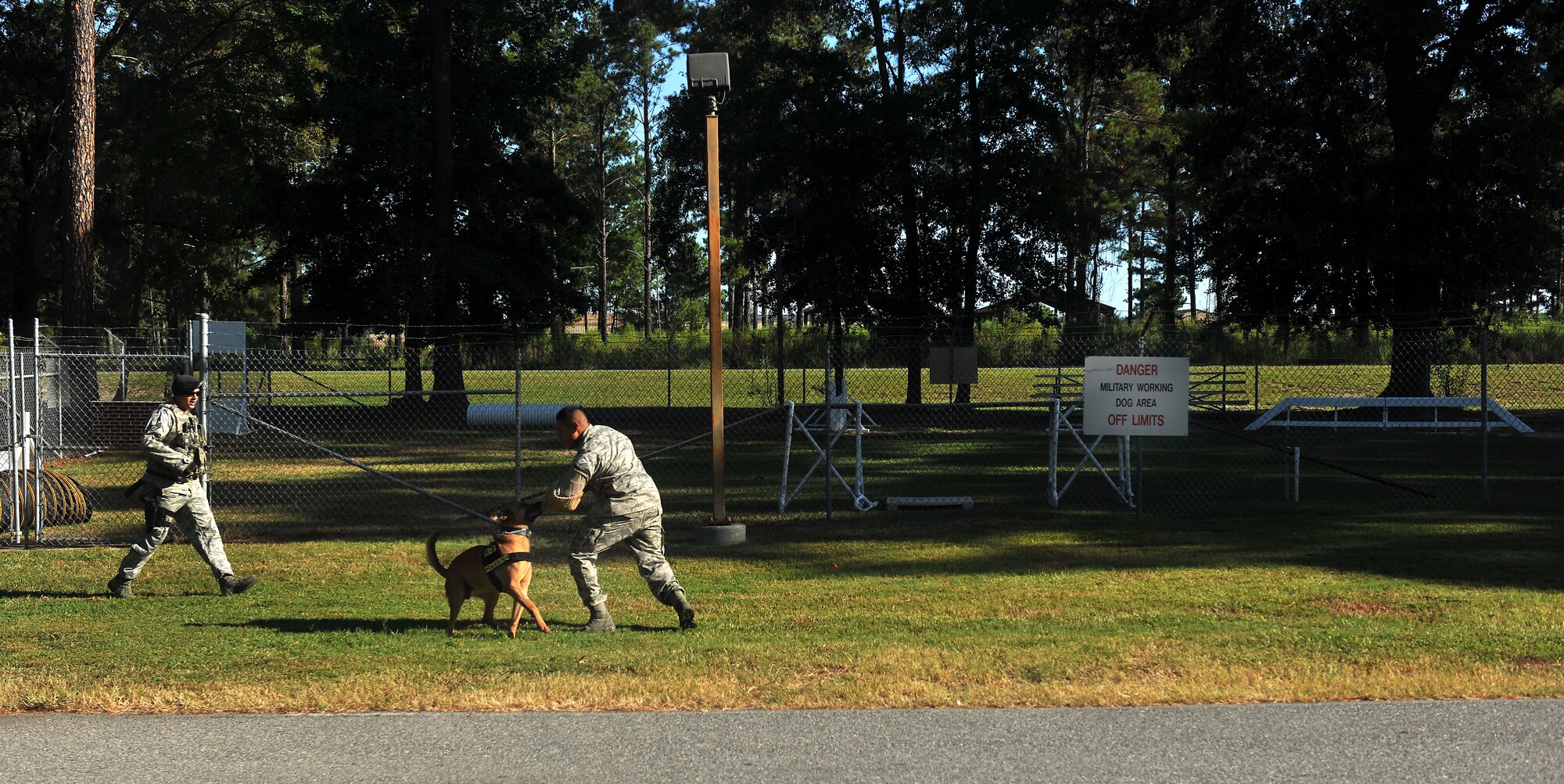 MOODY AIR FORCE BASE, Ga. -- Staff Sgt. Ryan Frederick, 23rd Security Forces Squadron military working dog handler runs behind Rico, MWD, as he attacks Senior Airman Steve Fuentes, 23rd SFS MWD handler, during a demonstration for members of the Colquitt County High School Marine Corps Junior ROTC  here Sept. 16. (U.S. Air Force photo/Airman 1st Class Joshua Green)


