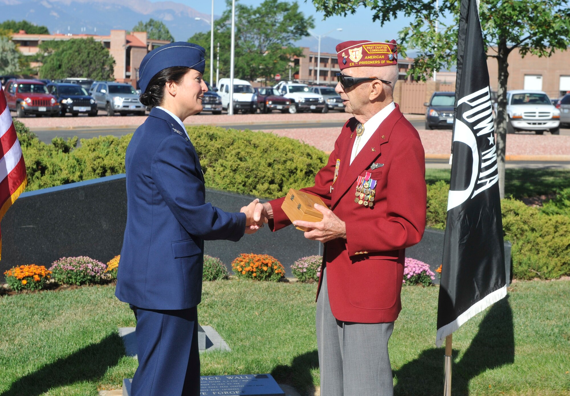 Col. Nina Armagno, 21st Operations Group commander, thanks Lt. Col. William Sheaves for his more than 30 years of military service during a Prisoner of War/Missing In Action Recognition Day ceremony Sept. 17 at the Peterson Air Force Base chapel. Colonel Sheaves was held prisoner in a German POW camp for 21 months during World War II. He shared his story with Peterson Airmen and graciously thanked them for their service. (U.S. Air Force photo/Robb Lingley)