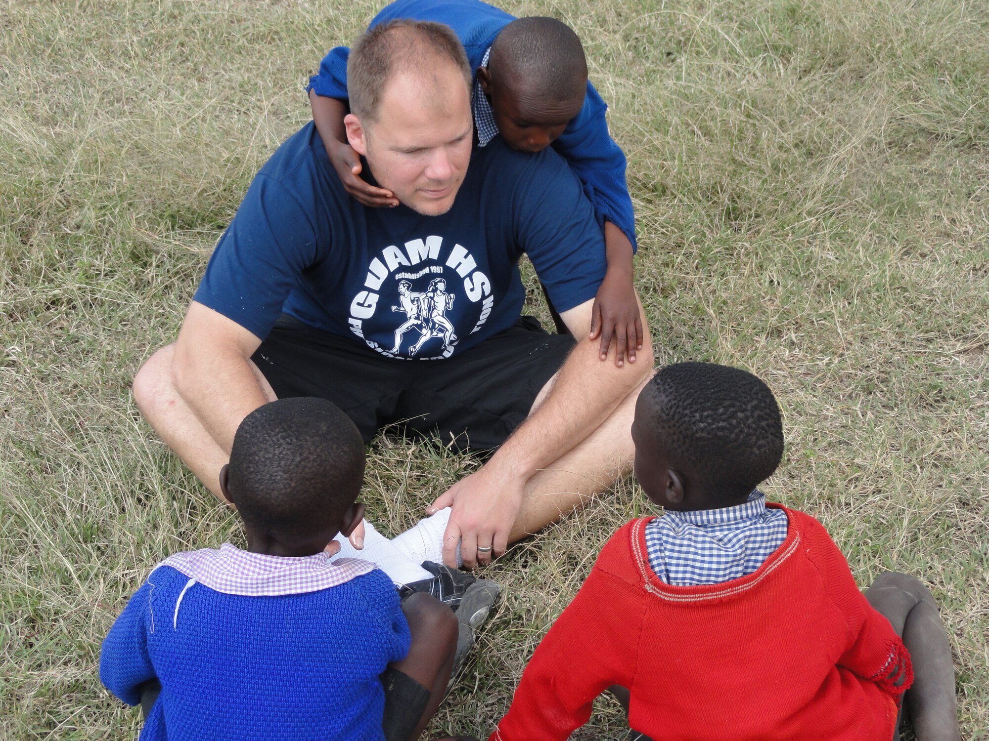 Maj. Jonathan Gration plays with children at the Hope for Life Orphanage in Nakuru, Kenya. Major Gration and his wife Capt. Julie Gration raised money to donate Solar Cookers to the women of Abu Shouk IDP camp in Sudan and traveled to Kenya to complete a service project at Hope for Life, an orphanage for children who have lost their parents to AIDS. Major Gration is assigned to the 90th Fighter Squadron and Captain Gration is a Reservist assigned to the 477th Fighter Group. (Courtesy Photo)