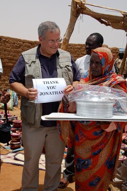 Scott Gration, U.S. Special Envoy to Sudan and father of Maj. Jonathan Gration, presents Solar Cookers to the women of Abu Shouk IDP camp in Sudan. Maj. Gration, a pilot assigned to the 90th Fighter Squadron, raised money to donate 125 Solar Cookers to the women of the camp. (Courtesy Photo)