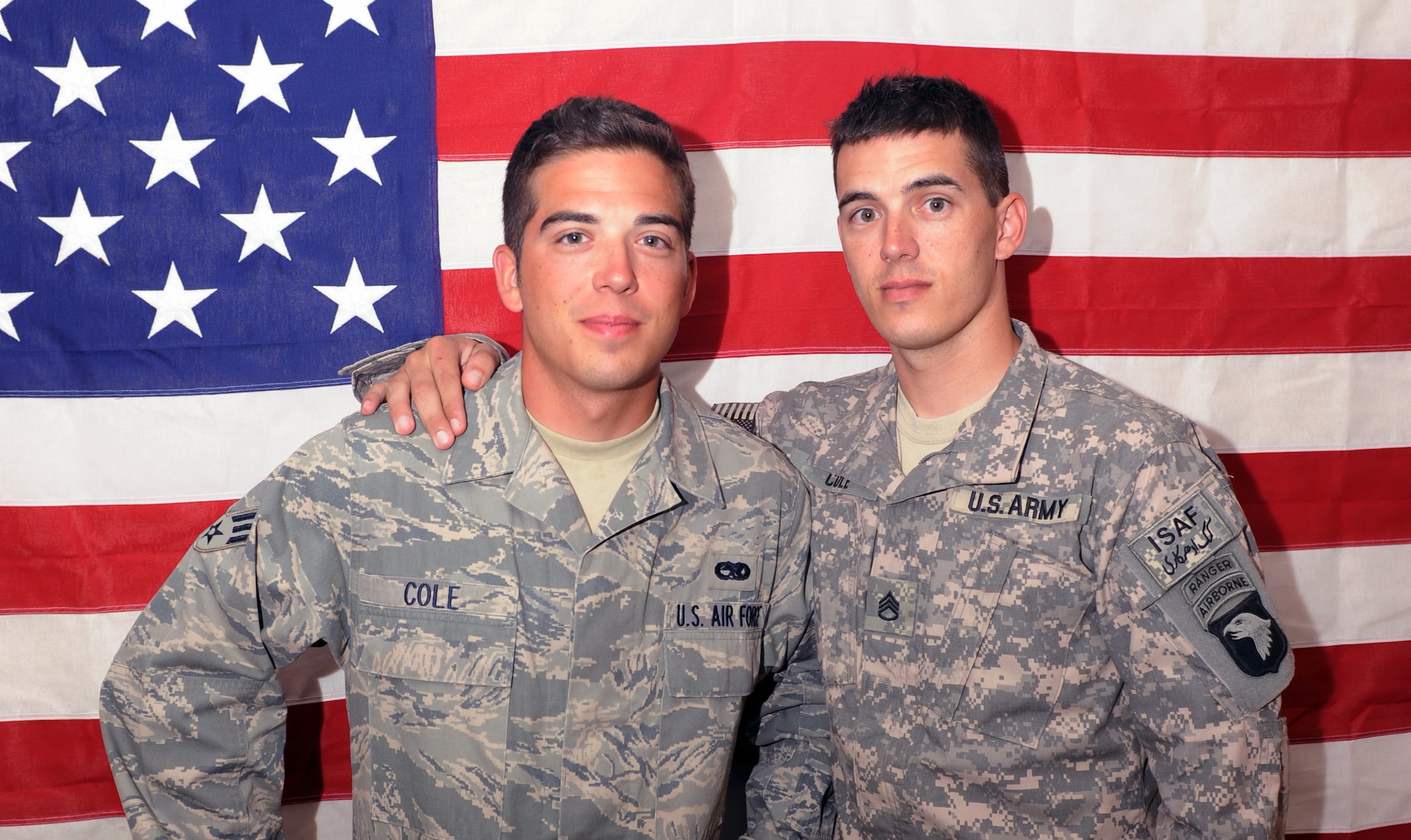 Army Staff Sgt. Jonathan Cole (left) and Senior Airman William Cole stand together at Bagram Airfield, Afghanistan. Sergeant Cole is a member of the 101st Airborne Division and Airman Cole is assigned to the 336th Aircraft Maintenance Unit at Bagram Airfield. (U.S. Air Force photo/Tech. Sgt. Drew Nystrom)