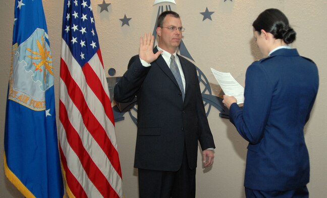 PATRICK AIR FORCE BASE, Fla. -- Lt. Col. Thomas Majcher (pronounced like "major"), a flight surgeon assigned to the 920th Rescue Wing, takes his oath to join the Air Force Reserve. His daughter, Lauren, a U.S. Air Force Second Lieutenant in medical school in Denver on an Air Force scholarship, swore him in.