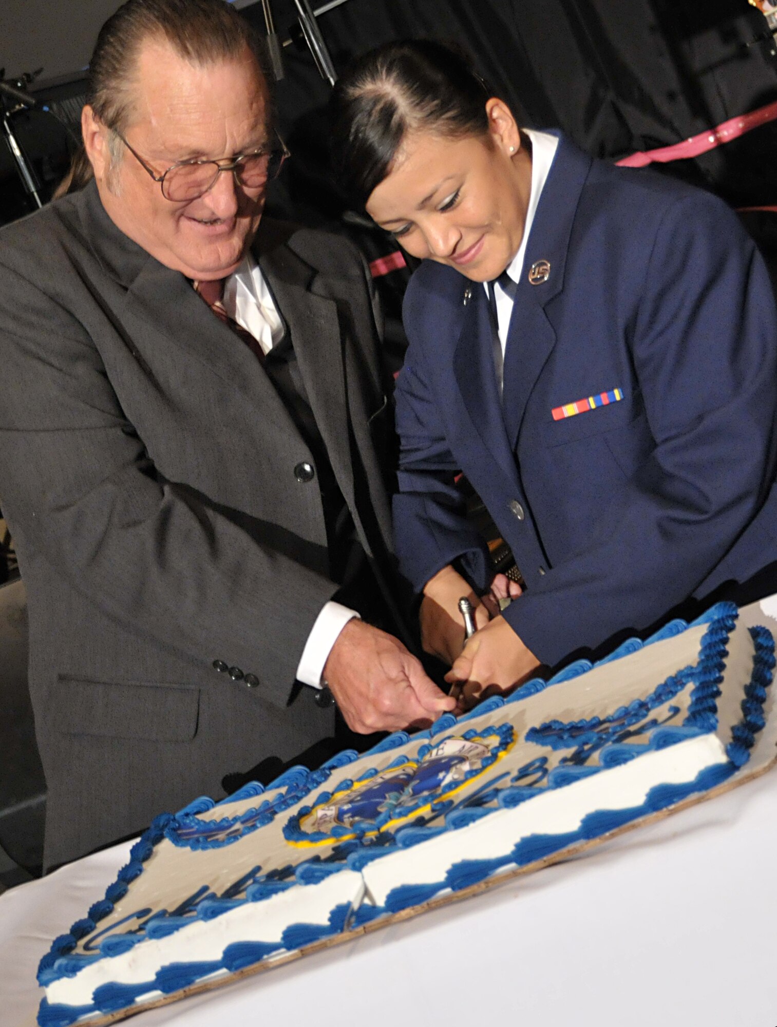 GOODFELLOW AIR FORCE BASE, Texas – Master Sgt. (ret.) John Gerende and Airman Basic Laura Garcia, 315th Training Squadron, the oldest and youngest Air Force members of the evening, cut the cake during the 63rd Annual Goodfellow Air Force Ball, Sept. 17. The three represents all facets of history: past, present and future. Mr. Gerende is also the brother-in-law of Army Warrant Officer 1, Luis Gallegeos Holguin, who was declared missing Jan 3, 1971. (U.S. Air Force photo/ Senior Airman Tong Duong)