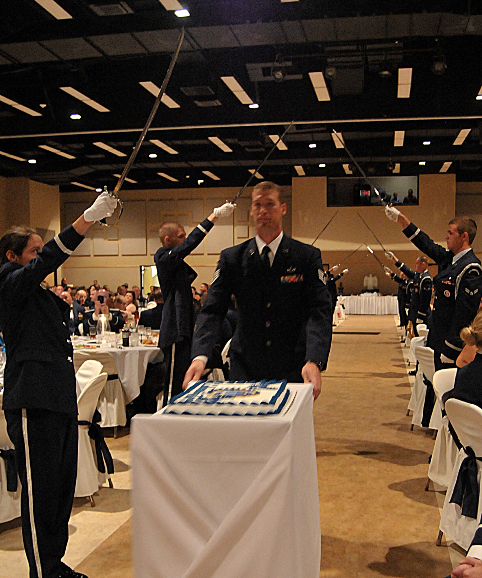 GOODFELLOW AIR FORCE BASE, Texas – Staff Sgt. Tyson Kauer, 316th Training Squadron, wheels out the birthday cake during the 63rd Annual Goodfellow Air Force Ball, Sept. 17. The cake is to celebrate the 63 years of the Air Force’s existence. (U.S. Air Force photo/ Senior Airman Tong Duong)
