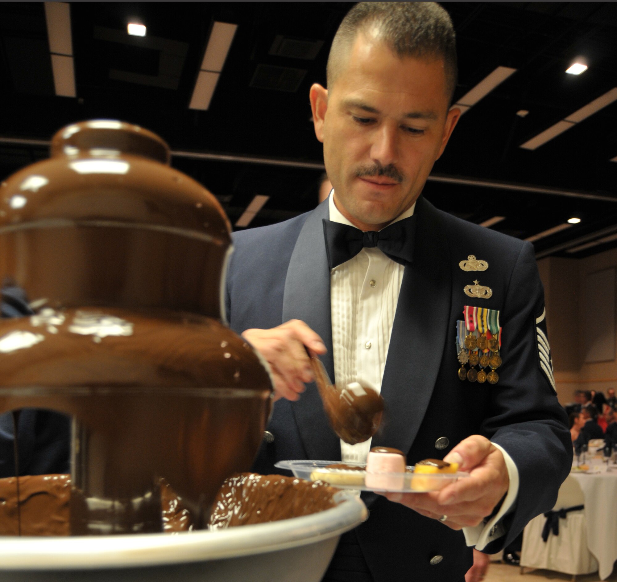 GOODFELLOW AIR FORCE BASE, Texas – Master Sgt. Christopher Hernandez, 17th Training Wing Judge Advocate, indulges his sweet tooth at the chocolate fountain, during the 63rd Annual Goodfellow Air Force Ball, Sept. 17. More than 600 attended the event. (U.S. Air Force photo/ Senior Airman Tong Duong)