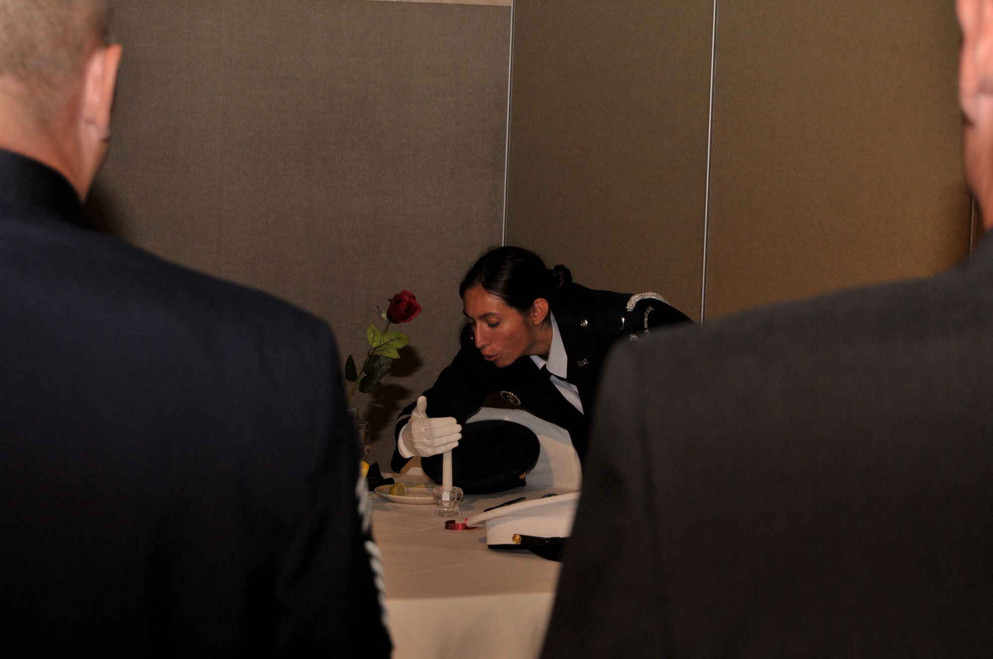GOODFELLOW AIR FORCE BASE, Texas – Honor Guard member, 1st Lt. Melissa Collins, 17th Civil Engineer Squadron, retires the Table of Honor during the 63rd Annual Goodfellow Air Force Ball, Sept. 17. The POW/MIA table symbolizes the fact that members of each branch of service are still missing. (U.S. Air Force photo/ Senior Airman Tong Duong)