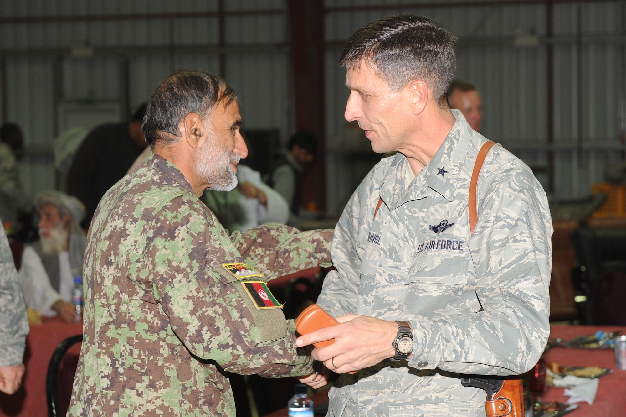 Brig. Gen. Paul Johnson, 451st Air Expeditionary Wing commander, greets Brig. Gen. Mohammed Yousef, Kandahar Air Wing vice commander, during the U.S. Air Force’s 63rd birthday celebration, Sept. 19, 2010, at Kandahar Airfield, Afghanistan.  The KAW hosted the 451st AEW and the 738th Air Expeditionary Advisory Group for a traditional meal and social event to commemorate the establishment of the U.S. Air Force. (U.S. Air Force photo by Tech. Sgt. Chad Chisholm/Released)