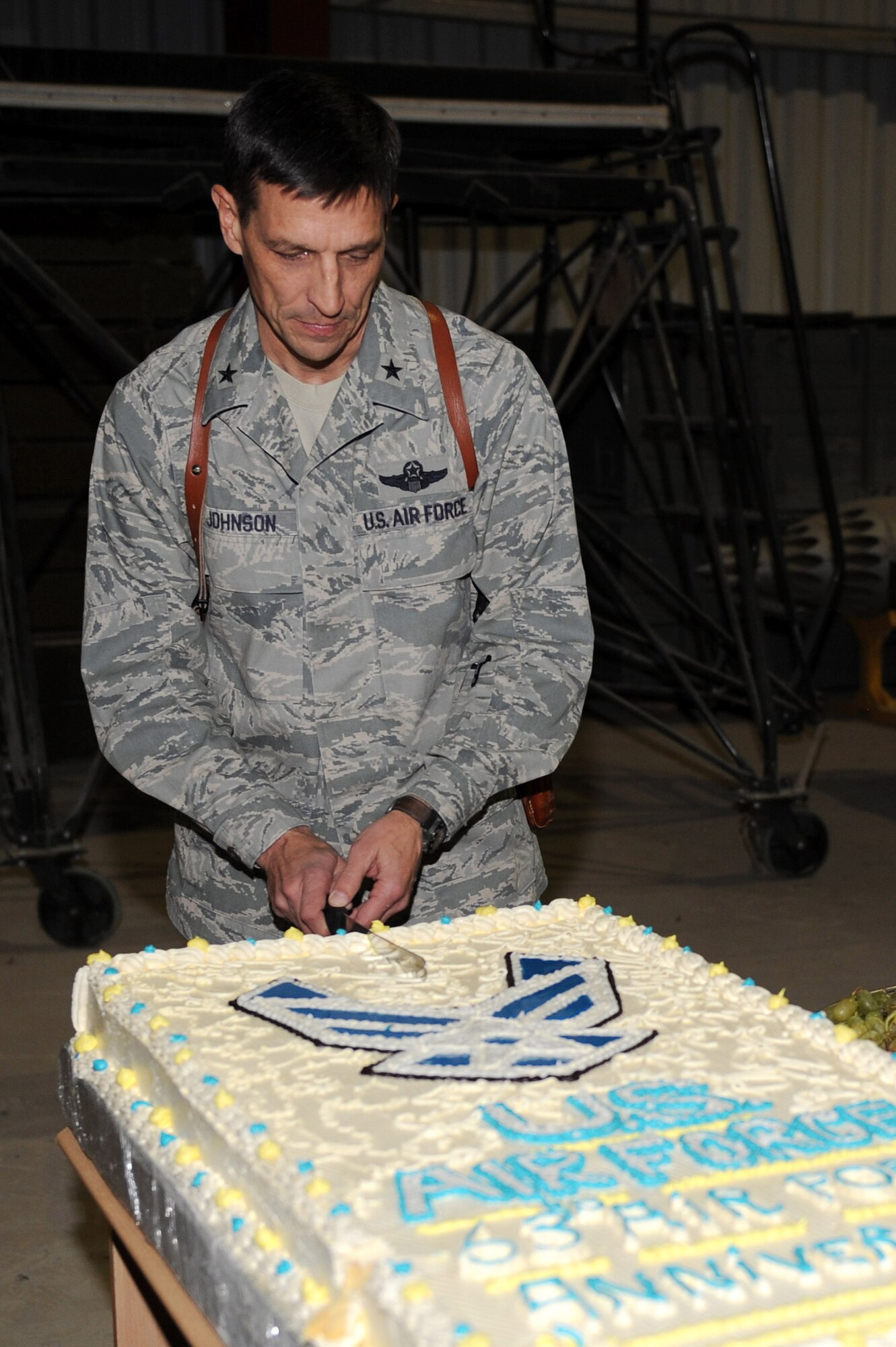 Brig. Gen. Paul Johnson, 451st Air Expeditionary Wing commander, cuts the cake during the U.S. Air Force’s 63rd birthday celebration, Sept. 19, 2010, at Kandahar Airfield, Afghanistan.  The Afghan Air Force’s Kandahar Air Wing hosted Airmen from the 451st AEW and the 738th Air Expeditionary Advisory Group for a traditional meal and social event to commemorate the establishment of the U.S. Air Force. (U.S. Air Force photo by Tech. Sgt. Chad Chisholm/Released)