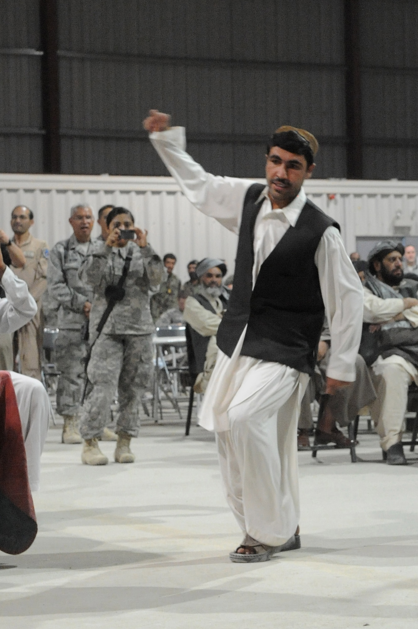 An Afghan dancer performs the Attan, a traditional Afghan folk dance, during the U.S. Air Force’s 63rd birthday celebration, Sept. 19, 2010, at Kandahar Airfield, Afghanistan.  The Kandahar Air Wing hosted Airmen from the 451st Air Expeditionary Wing and the 738th Air Expeditionary Advisory Group for a traditional meal and social event to commemorate the establishment of the U.S. Air Force. (U.S. Air Force photo by Tech. Sgt. Chad Chisholm/Released)