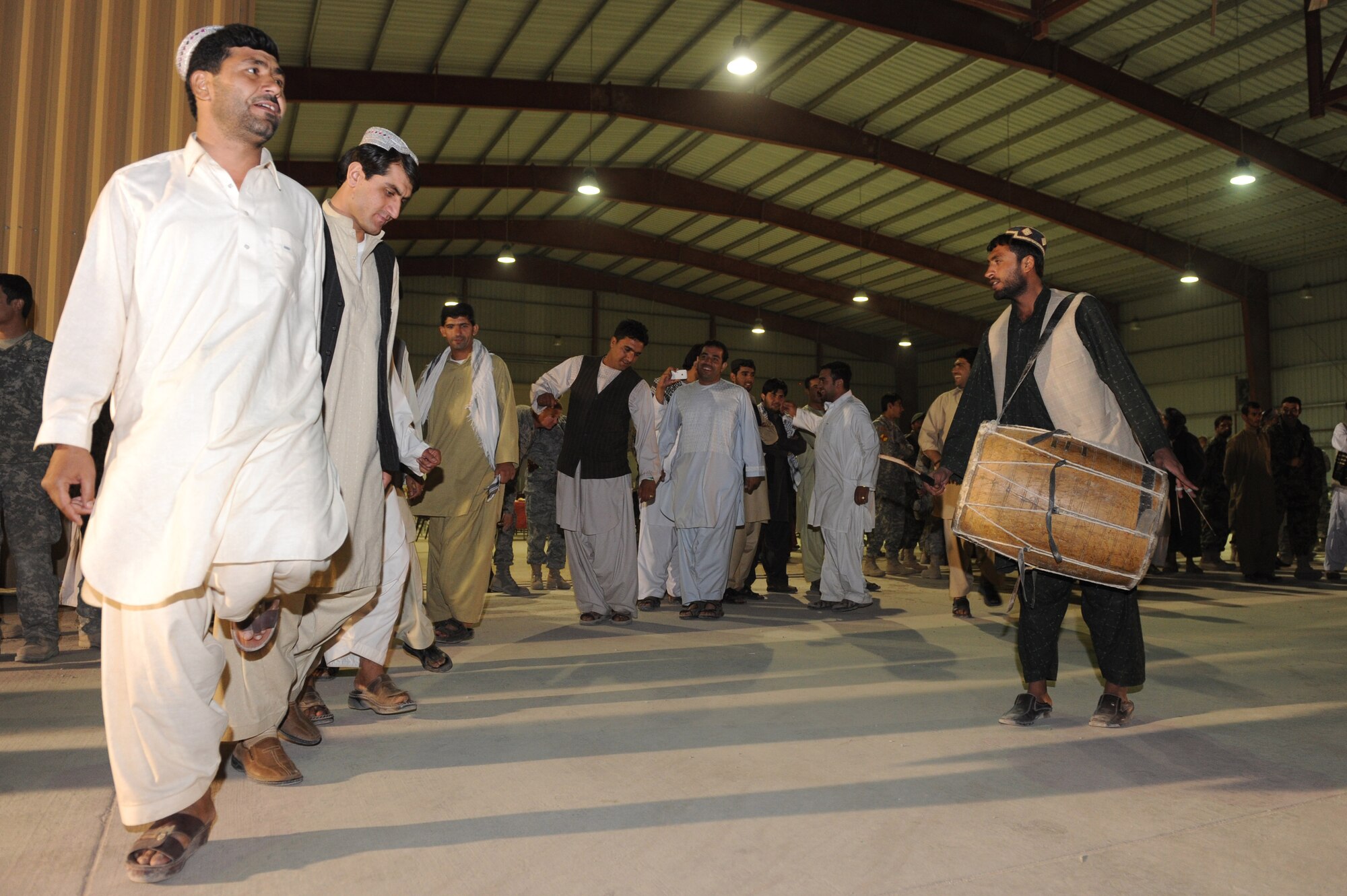 An Afghan dance troupe performs the Attan, a traditional Afghan folk dance, during the U.S. Air Force’s 63rd birthday celebration, Sept. 19, 2010, at Kandahar Airfield, Afghanistan.  The Kandahar Air Wing hosted Airmen from the 451st Air Expeditionary Wing and the 738th Air Expeditionary Advisory Group for a traditional meal and social event to commemorate the establishment of the U.S. Air Force. (U.S. Air Force photo by Tech. Sgt. Chad Chisholm/Released)