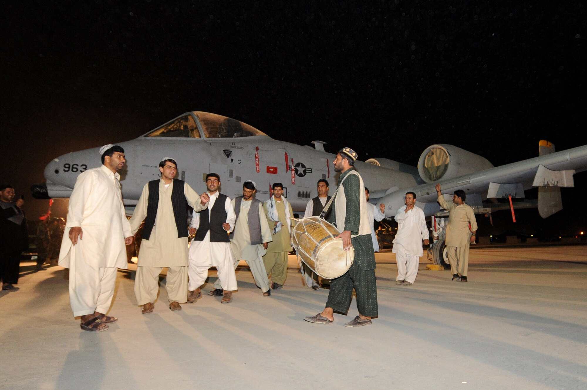 An Afghan dance troupe performs the Attan, a traditional Afghan folk dance, in front of an A-10 Thunderbolt II, Sept. 19, 2010, at Kandahar Airfield, Afghanistan.  The Kandahar Air Wing hosted Airmen from the 451st Air Expeditionary Wing and the 738th Air Expeditionary Advisory Group for a traditional meal and social event to celebrate the U.S. Air Force’s 63rd birthday. (U.S. Air Force photo by Tech. Sgt. Chad Chisholm/Released)