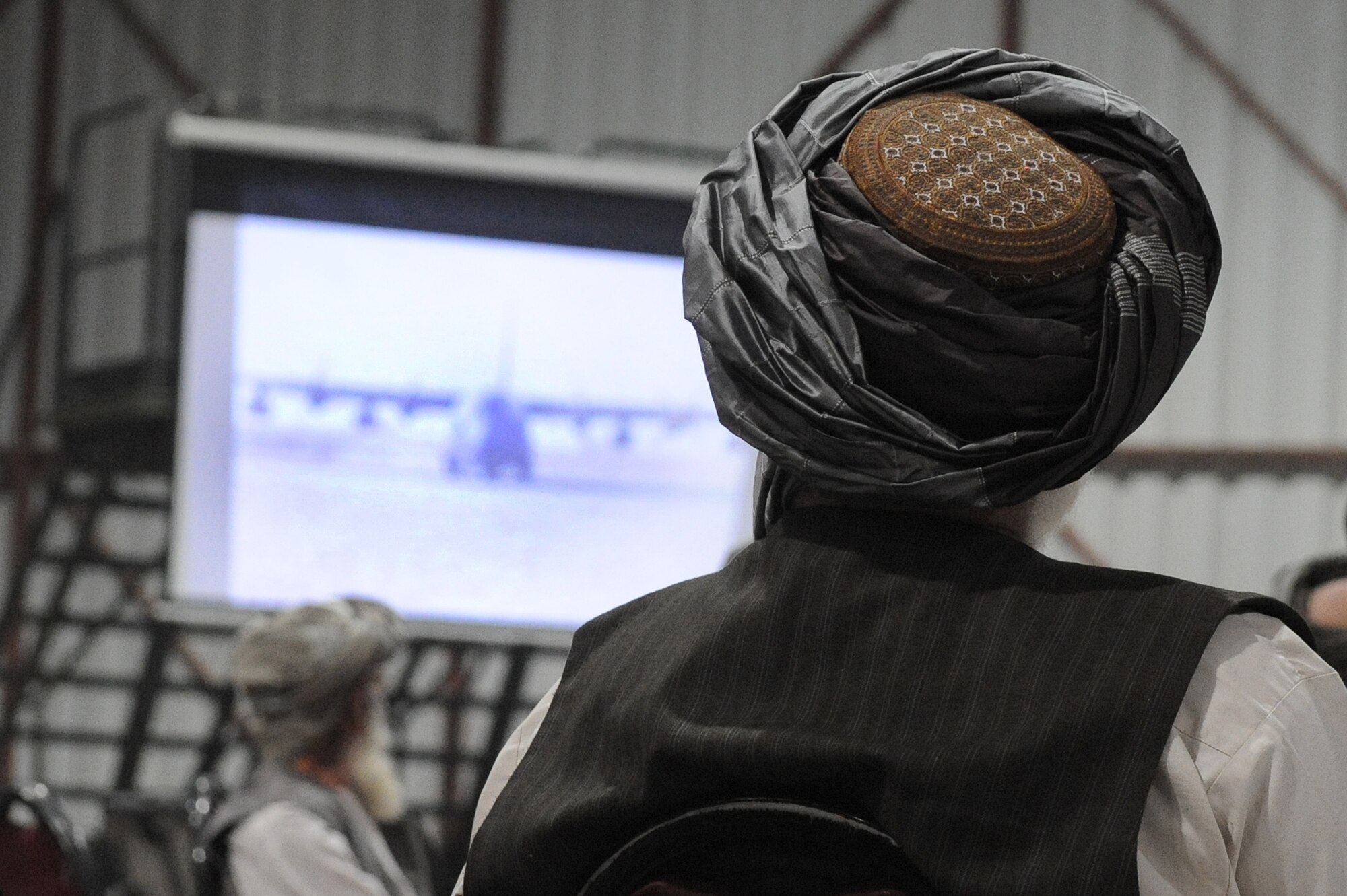 Kandahar provincial elders watch a historical slideshow during the U.S. Air Force’s 63rd birthday celebration, Sept. 19, 2010, at Kandahar Airfield, Afghanistan.  The Kandahar Air Wing hosted Airmen from the 451st Air Expeditionary Wing and the 738th Air Expeditionary Advisory Group for a traditional meal and social event to commemorate the establishment of the U.S. Air Force. (U.S. Air Force photo by Tech. Sgt. Chad Chisholm/Released)