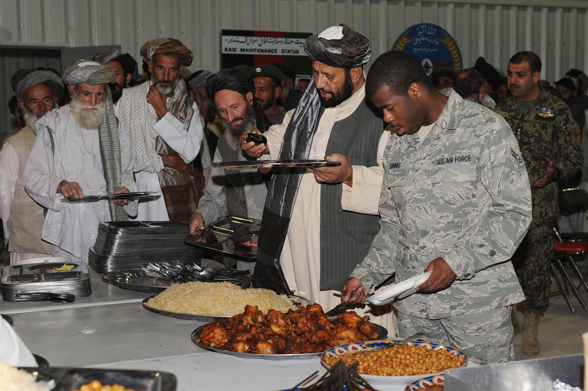 Airman 1st Class Bryan Simms prepares to dine with Kandahar provincial elders during the U.S. Air Force’s 63rd birthday celebration, Sept. 19, 2010, at Kandahar Airfield, Afghanistan.  The Kandahar Air Wing hosted Airmen from the 451st Air Expeditionary Wing and the 738th Air Expeditionary Advisory Group for a traditional meal and social event to commemorate the establishment of the U.S. Air Force. (U.S. Air Force photo by Tech. Sgt. Chad Chisholm/Released)