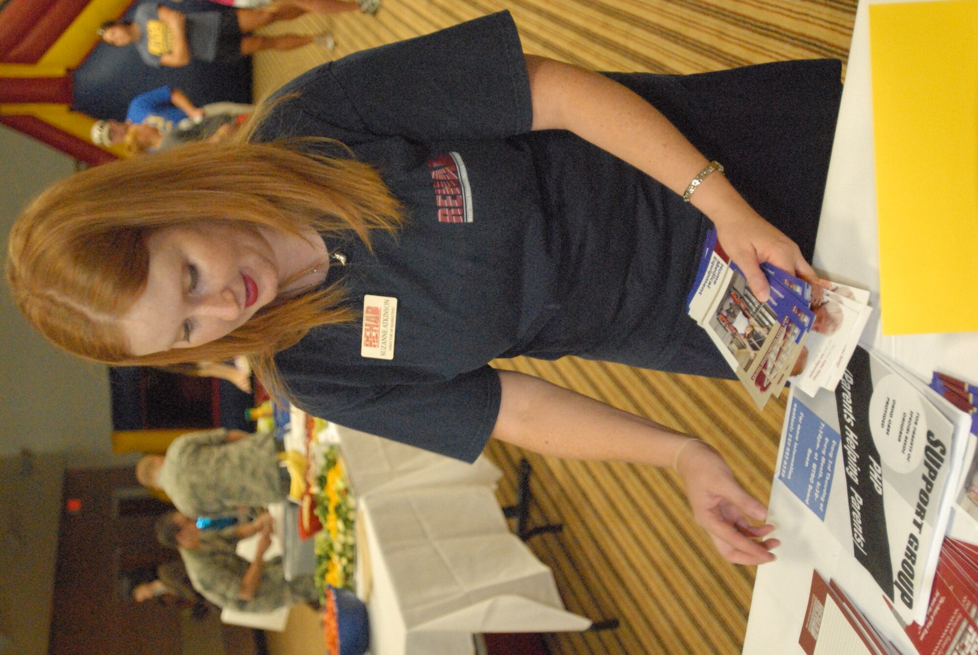 Suzanne Atkinson, West Texas Rehab marketing director, sets up her booth at the first-ever family fun and information fair Sept. 18 at the Event Center. The Air Force Aid Society Funded event offered parents of special needs children various information while crafts and other activities for the children were held by training student volunteers. (U.S. Air Force photo/Connie Hempel)