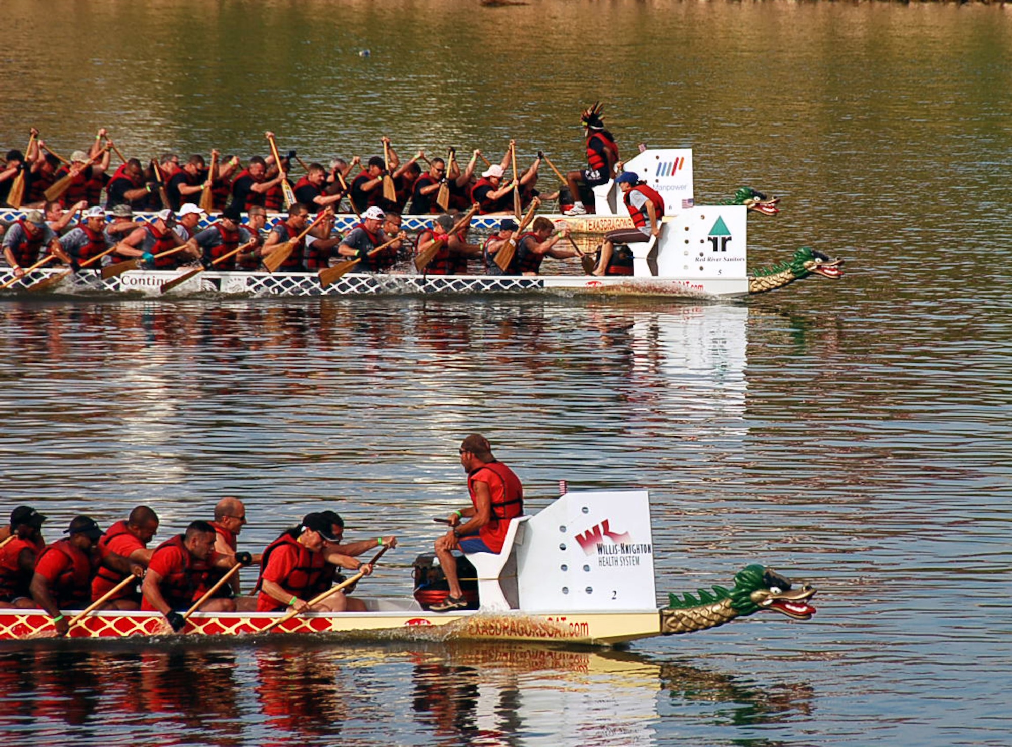 SHREVEPORT, La. – The Eighth Air Force dragon boat team (top) slowed to a fourth place finish in the final race of the day Sept. 11. Air Force Global Strike Command (middle) came in second place and the defending champions Fire Department Team (red) reclaim their championship crown. The team competed against 26 other teams during the 2nd Annual Red River Dragon Boat Festival held at the River View Park in Shreveport, La. The races feature 41-foot-long dragon boats that hold 21 team members. (U.S. Air Force photo by Staff Sgt. Brian Stives)