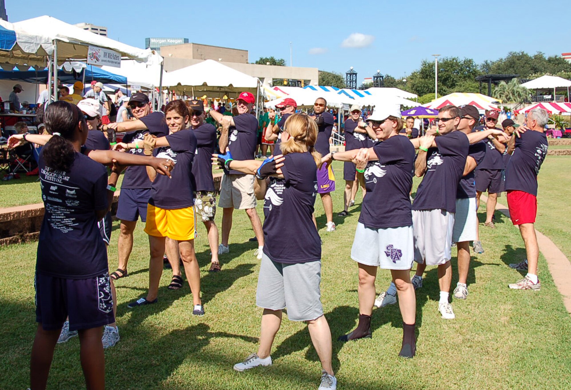 SHREVEPORT, La. – Members of the Eighth Air Force dragon boat team stretch before their first race of the day Sept. 11. The team competed against 26 other teams during the 2nd Annual Red River Dragon Boat Festival held at the River View Park in Shreveport, La. The races feature 41-foot-long dragon boats that hold 21 team members, Eighth Air Force finished second in last year’s race. (U.S. Air Force photo by Staff Sgt. Brian Stives)