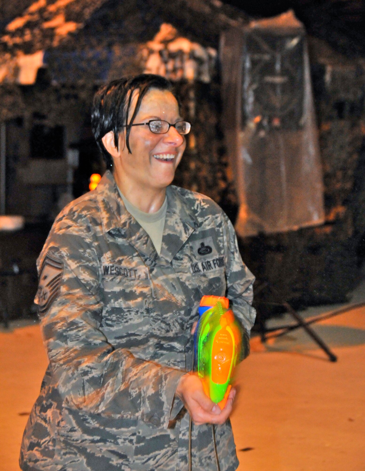 WRIGHT-PATTERSON AIR FORCE BASE, Ohio – Senior Master Sgt. Janet Wescott, 445th Civil Engineer Squadron first sergeant, takes part in a water gun fight during the Sept. 11 Wright-Patterson Air Force Base Enlisted Combat Dining-In. (U.S. Air Force photo/Master Sgt. John Koehl)