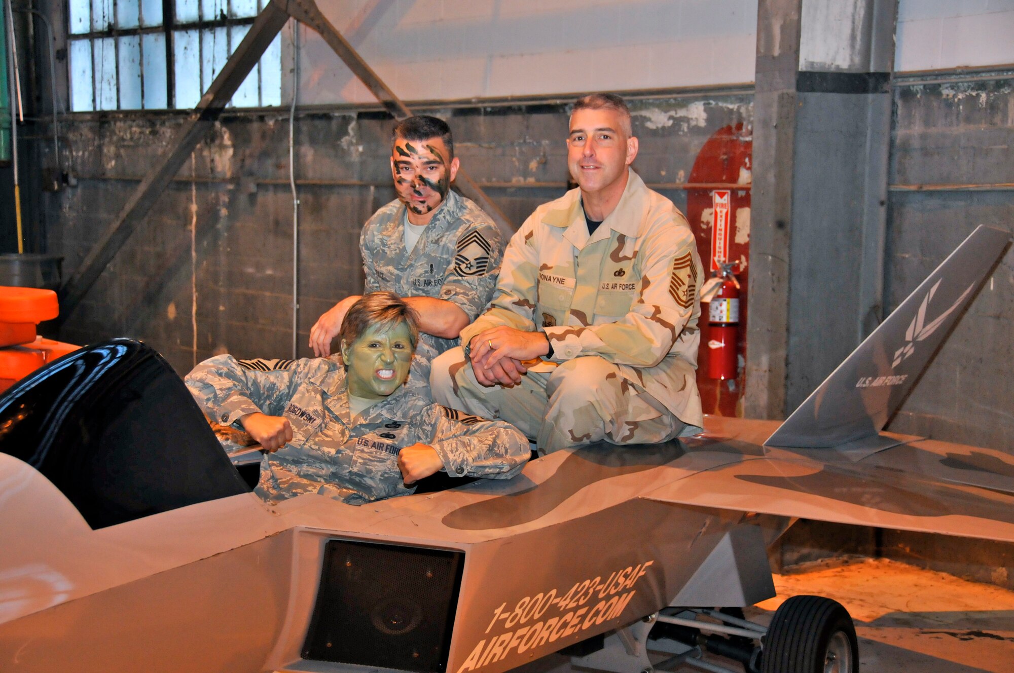 WRIGHT-PATTERSON AIR FORCE BASE, Ohio – Chief Master Sgt. Peri Rogowski, 445th Airlift Wing command chief, gets into the spirit of the Wright-Patterson Air Force Base Enlisted Combat Dining-in Sept. 11 with Chief Master Sgt. Edward Pace, 88th Medical Group, and Chief Master Sgt. Michael Ronayne, NASIC command chief. A Saber Arch with Super Soakers stood at the entrance for the official party upon their arrival. (U.S. Air Force photo/Master Sgt. John Koehl)
