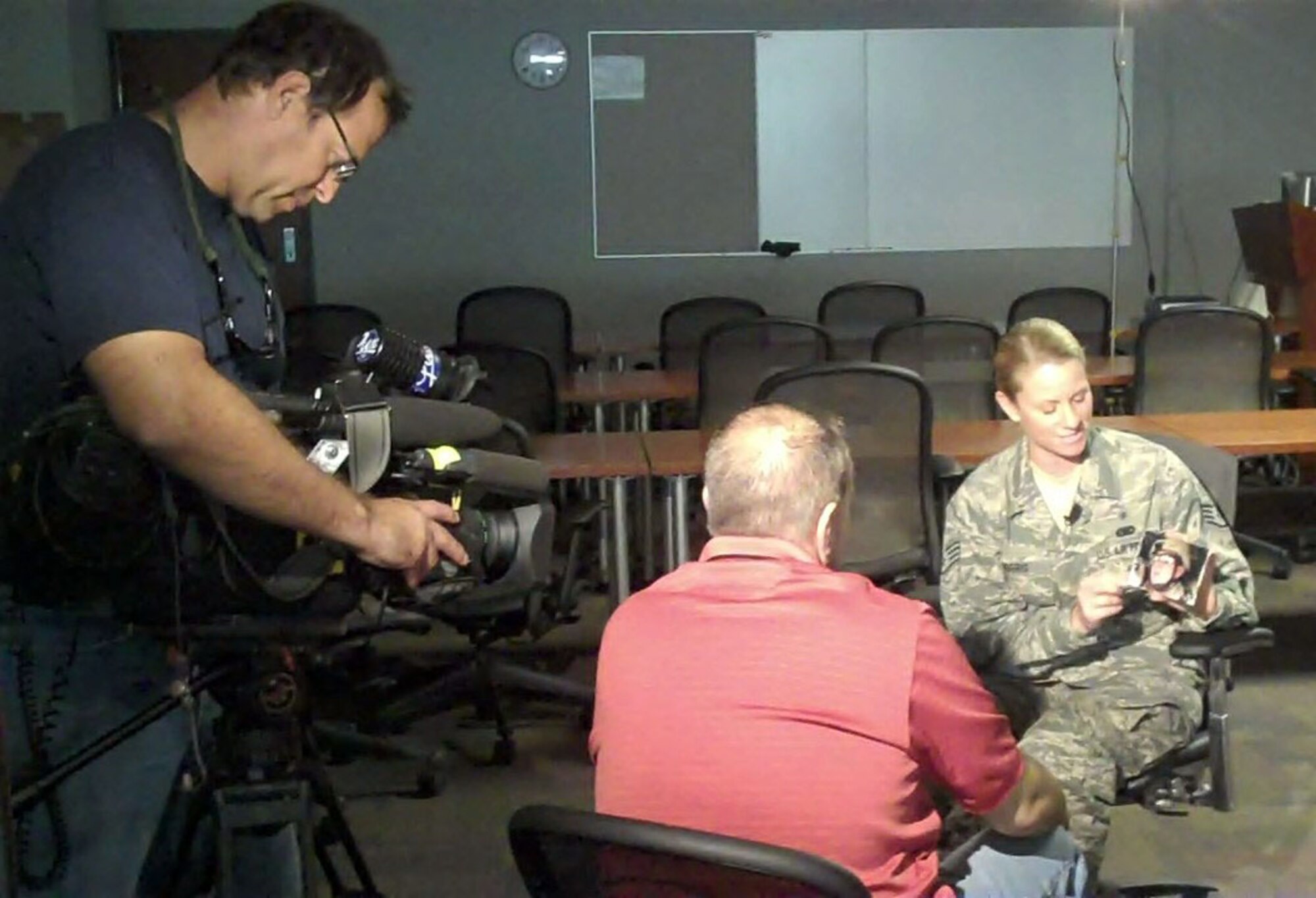 Staff Sgt. Michele Norris talks about her son Jeremy, who died in Iraq in 2005, with Mark Falgout, WTVD-ABC11 news producer. (USAF photo by Staff Sgt. Terrica Y. Jones 916 ARW/PA)
