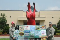 Capt. Chris Woofter and TSgt. Stephen Woofter hold the quilt made by their mother out of shirts from various marathons they've raced in together. The two shared their story with WTVD ABC 11 that aired on Sept. 16. (USAF photo by SSgt. Terrica Jones, 916ARW/PA)