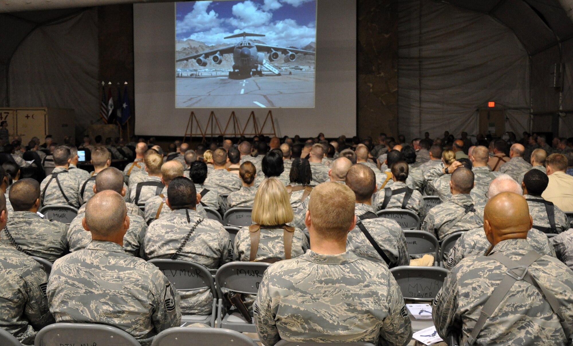 Attendees watch a short video and slide presentation highlighting various aspects of Air Force history during a ceremony for the Air Force's 63rd birthday celebration.  More than 200 Army and Air Force servcicemembers attended the ceremony along with a delegation from the Iraqi Air Force.  (U.S. Air Force photo by Tech. Sgt. Mike Edwards)