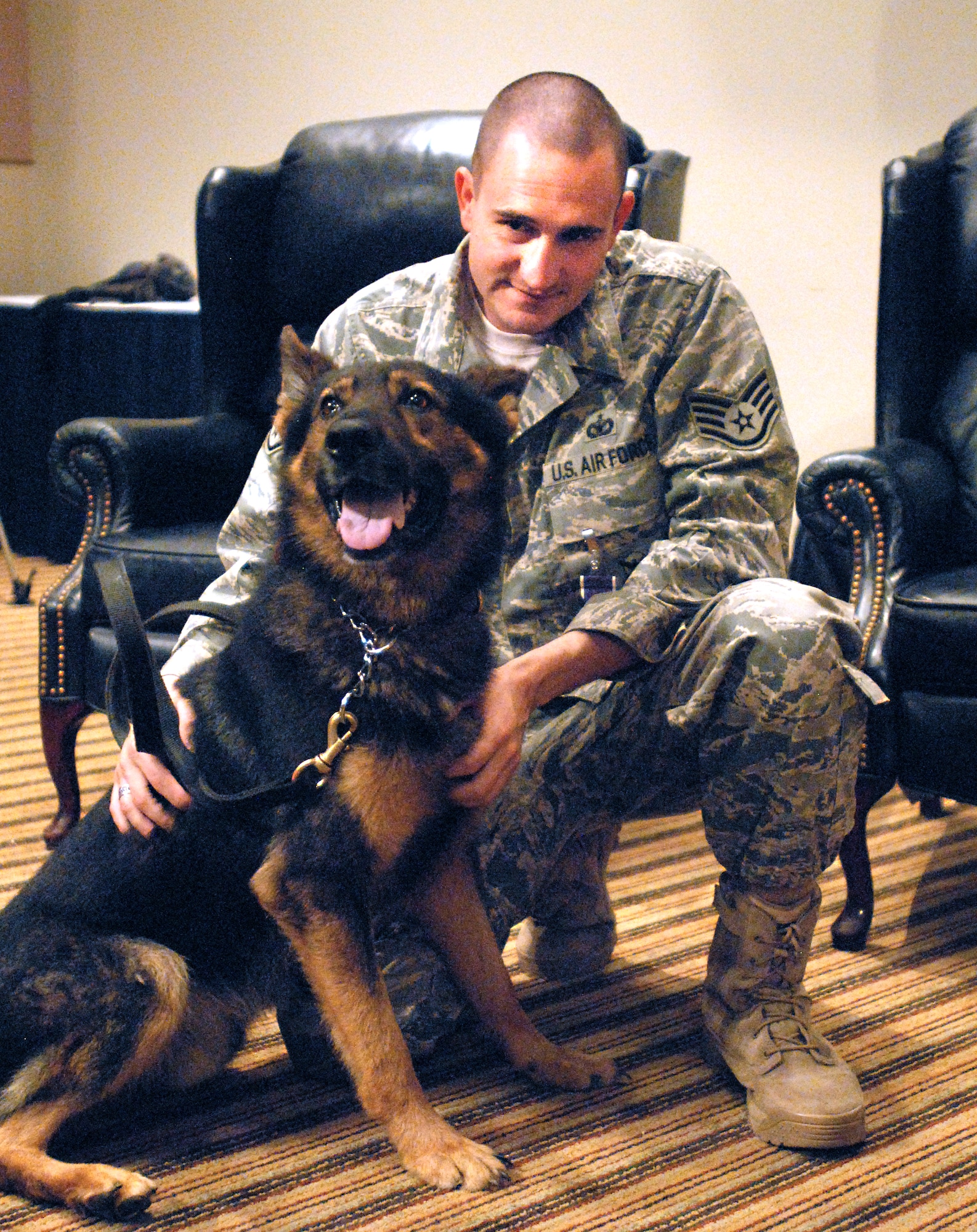 Staff Sgt. Dustin Vigil, 17th Security Forces Squadron K-9 handler, and his former military working dog, Spidla, after Sergeant Vigil's Purple Heart ceremony Sept. 17 at the Event Center. (U.S. Air Force photo/Master Sgt. Randy Mallard)