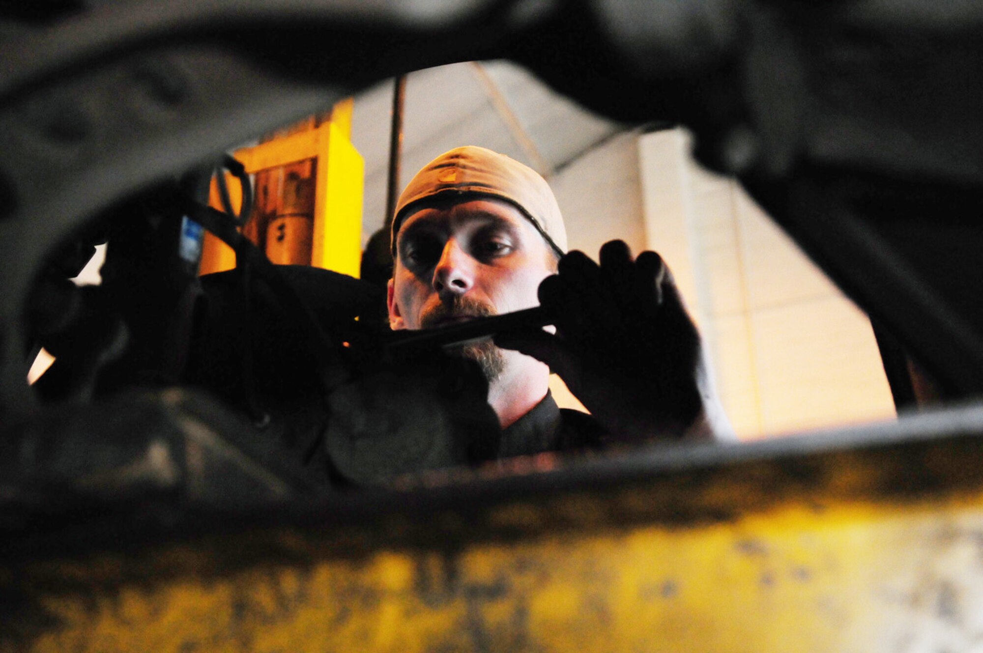 RAF MILDENHALL, England -- Brian Muse, 100th Force Support Squadron Auto Hobby Shop mechanic, works on replacing a sway bar link on a customer's car in one of the bays here Sept. 17. For those wanting to work on their own car, bays may be rented for $5 per hour. Alternatively, an auto hobby shop mechanic can fix customers' cars for $60 per hour, plus parts. (U.S. Air Force photo/Karen Abeyasekere)