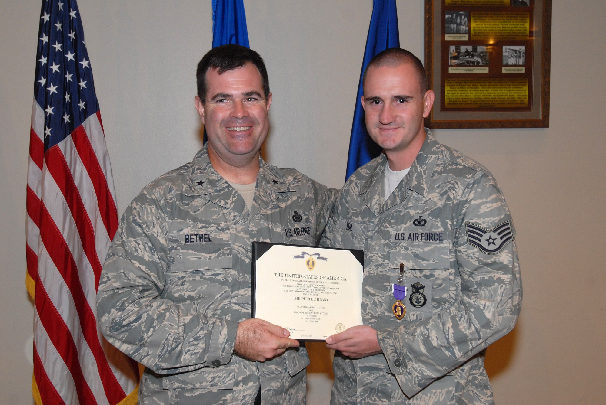 Staff Sgt. Dustin Vigil, 17th Security Forces Squadron K-9 handler, stands with Brig. Gen. Scott Bethel, Strategy, Integration and Doctrine Director and Deputy Chief of Staff for Intelligence, Surveillance and Reconnaissance at Headquarters U.S. Air Force in Washington, D.C., after receiving his Purple Heart medal for injuries he sustained from a mortar explosion in 2003. (U.S. Air Force photo/Master Sgt. Randy Mallard)