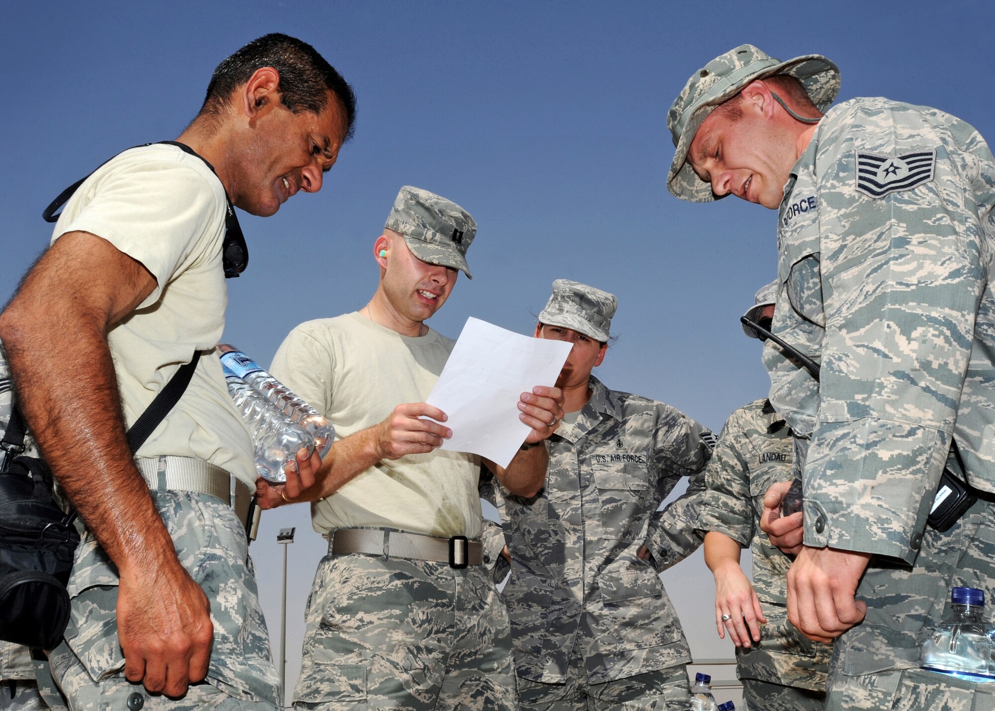 SOUTHWEST ASIA - Capt. Michael Oetjens of the 386th Expeditionary Medical Squadron reads instructions to his team during an 'Amazing Race' event at an undisclosed air base here Sept. 18, 2010. Participants were required to accomplish an assigned task as quickly as possible before moving on to another mission. The event was one of several activities held on base as part of the Air Force's 63rd birthday celebration. (U.S. Air Force photo by Senior Airman Laura Turner)    