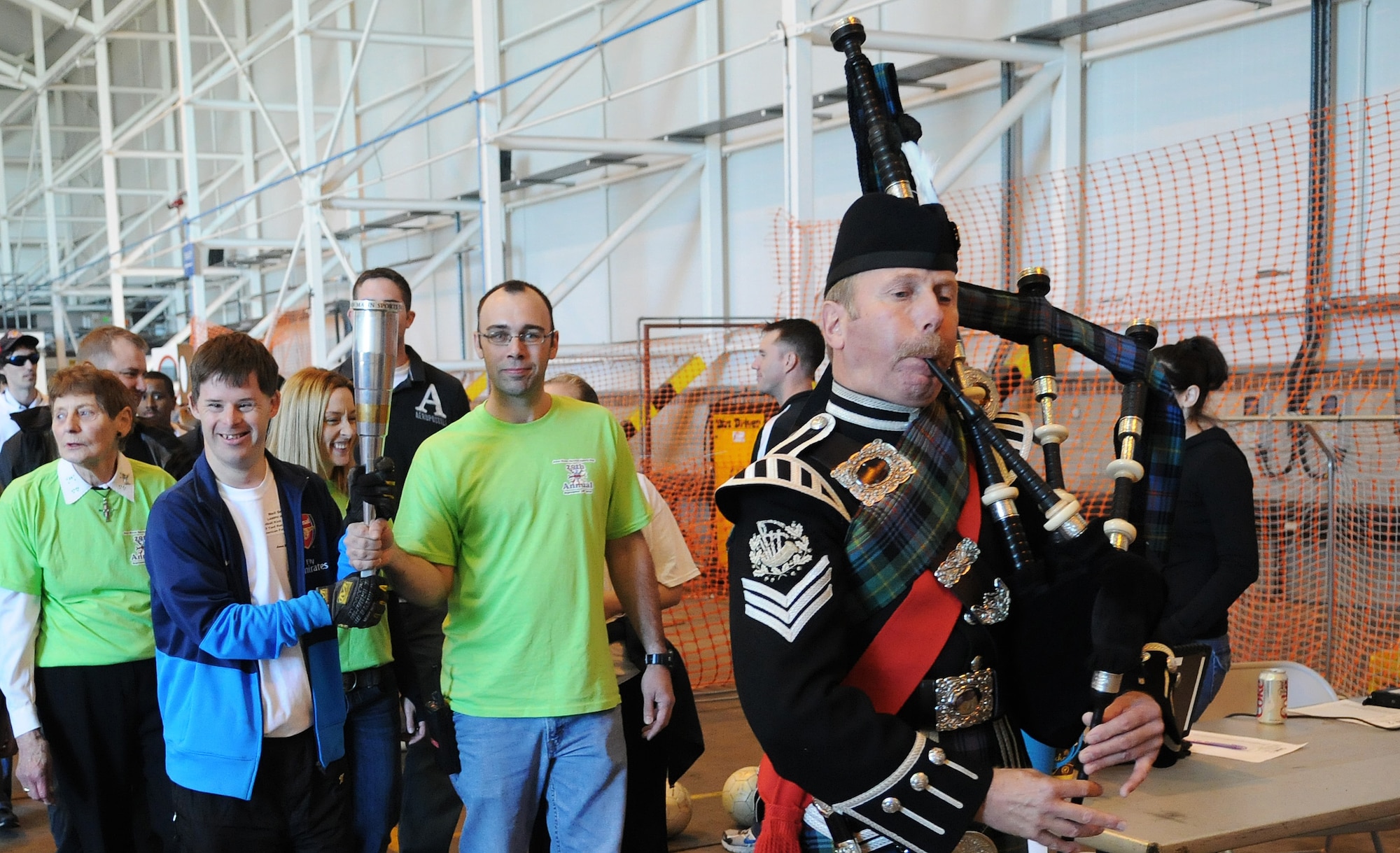 RAF MILDENHALL, England -- Athletes and volunteers for the 29th Annual Joan Mann Special Sports Day perform the Parade of Athletes at Hangar 711 Sept. 18. The event is geared to allow special-needs athletes an atmosphere for friendly competition. It was started by Joan Mann, a former Ministry of Defence employee working in the public affairs office here. (U.S. Air Force photo/Staff Sgt. Thomas Trower)