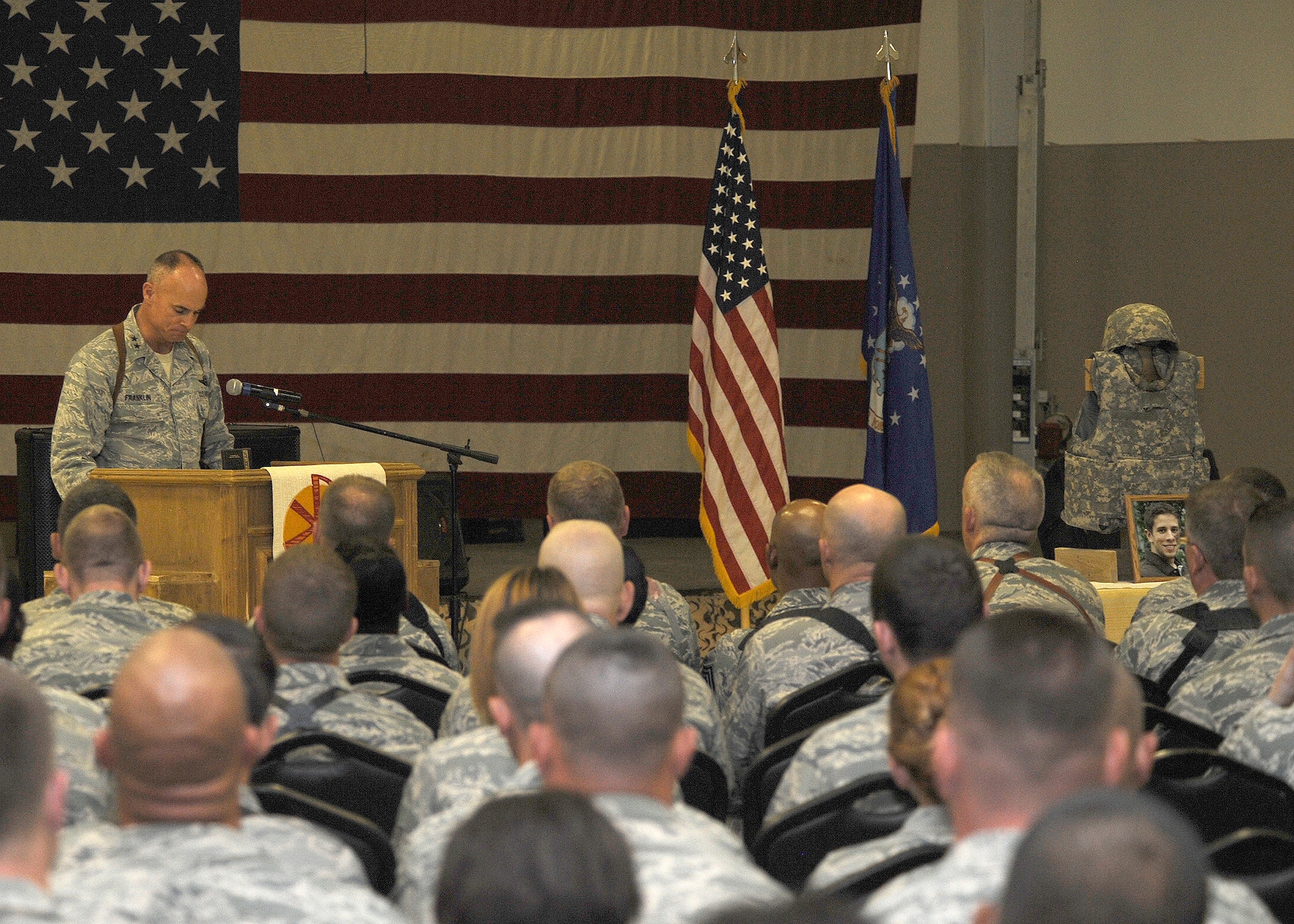 Maj. Gen. Craig Franklin, 332nd Air Expeditionary Wing commander, speaks on the contributions made to the wing by Senior Airman James Hansen as servicemembers pay tribute to his life in a memorial service Sept. 19, 2010 at Joint Base Balad, Iraq.  Airman Hansen, 25, an airfield operations manager assigned to the 332nd Expeditionary Operations Support Squadron, died in an explosive ordnance disposal accident here Sept. 15.  The ceremony included the reading of the citation for the Air Force Commendation Medal for Airman Hansen's exemplary service during his deployment from the 46th Operations Support Squadron, Eglin Air Force Base, Fla., in support of Operation Iraqi Freedom and Operation New Dawn.