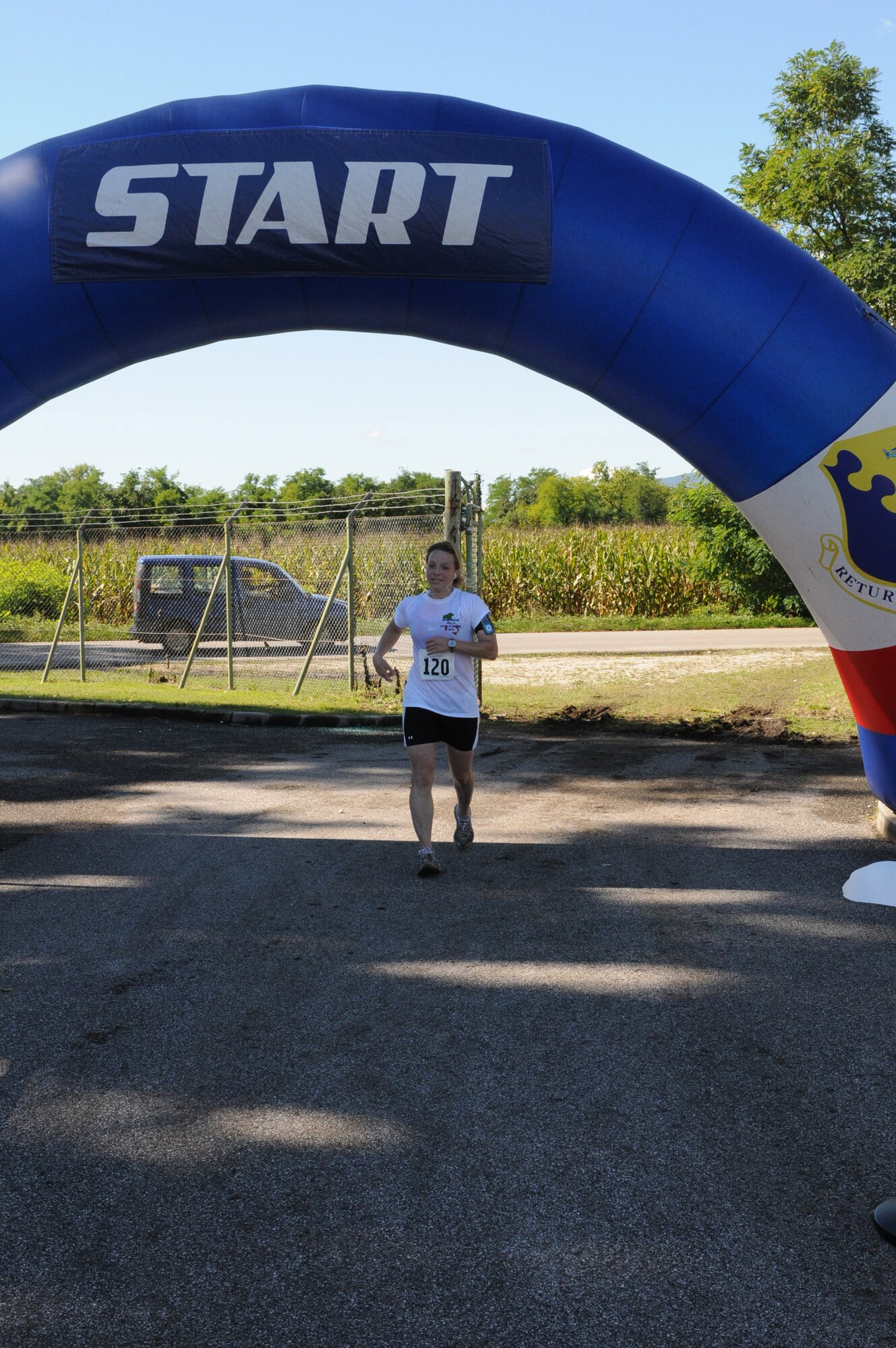 Senior Airman Sarah Stock, 31st Security Forces Squadron plans and programs clerk, reaches the finish line during the fourth annual Aviano Marathon Sept. 19 at Area D. More than 150 runners participated in the event that included 5k and 10K runs, a mile-long kids' run, half and full marathons. (U.S. Air Force photo/Staff Sgt. Julius Delos Reyes)