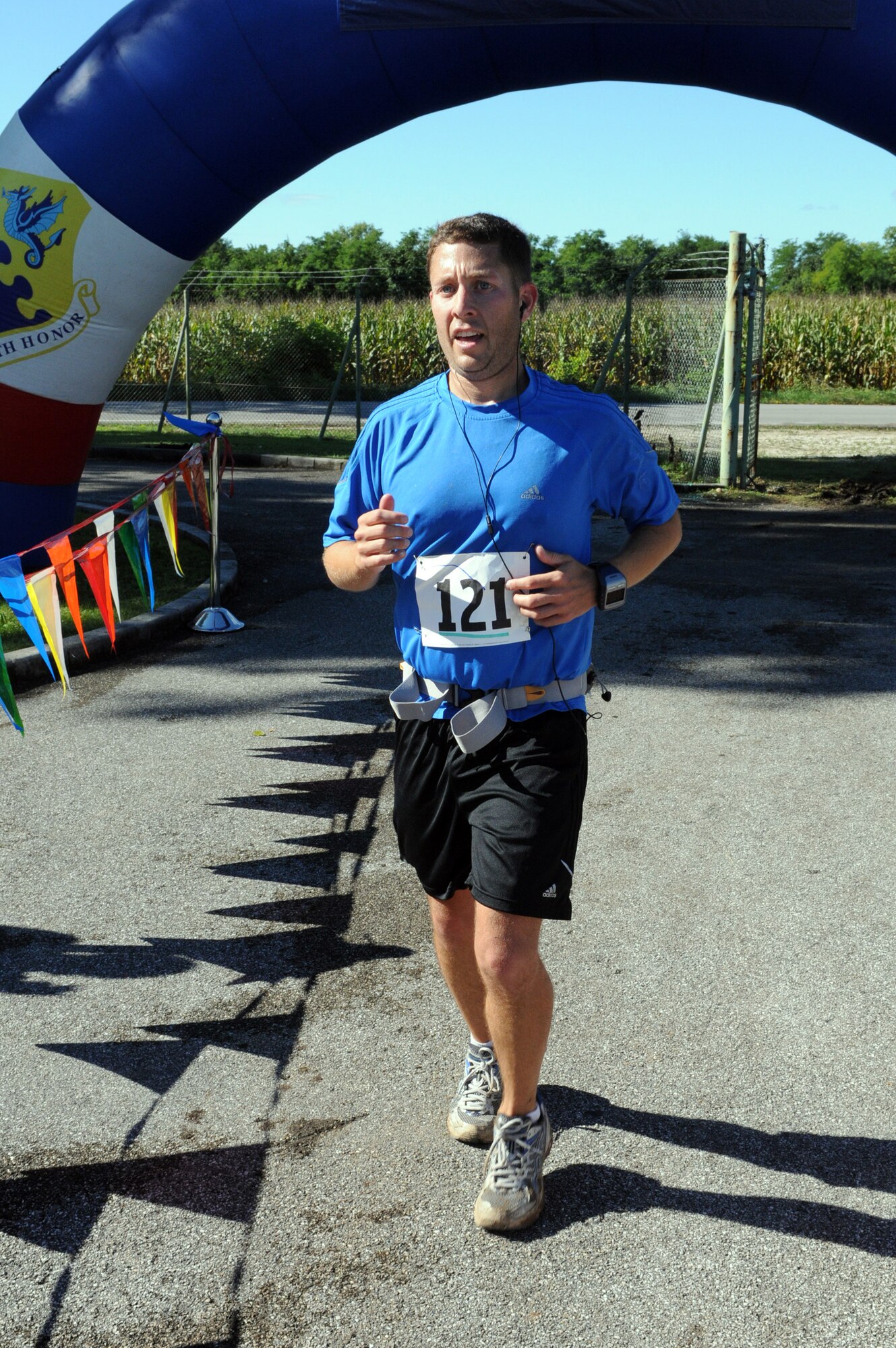 Blake Little, a physical education teacher from the DoDD School, reaches the finish line during the fourth annual Aviano Marathon Sept. 19 at Area D. (U.S. Air Force photo/Staff Sgt. Julius Delos Reyes)