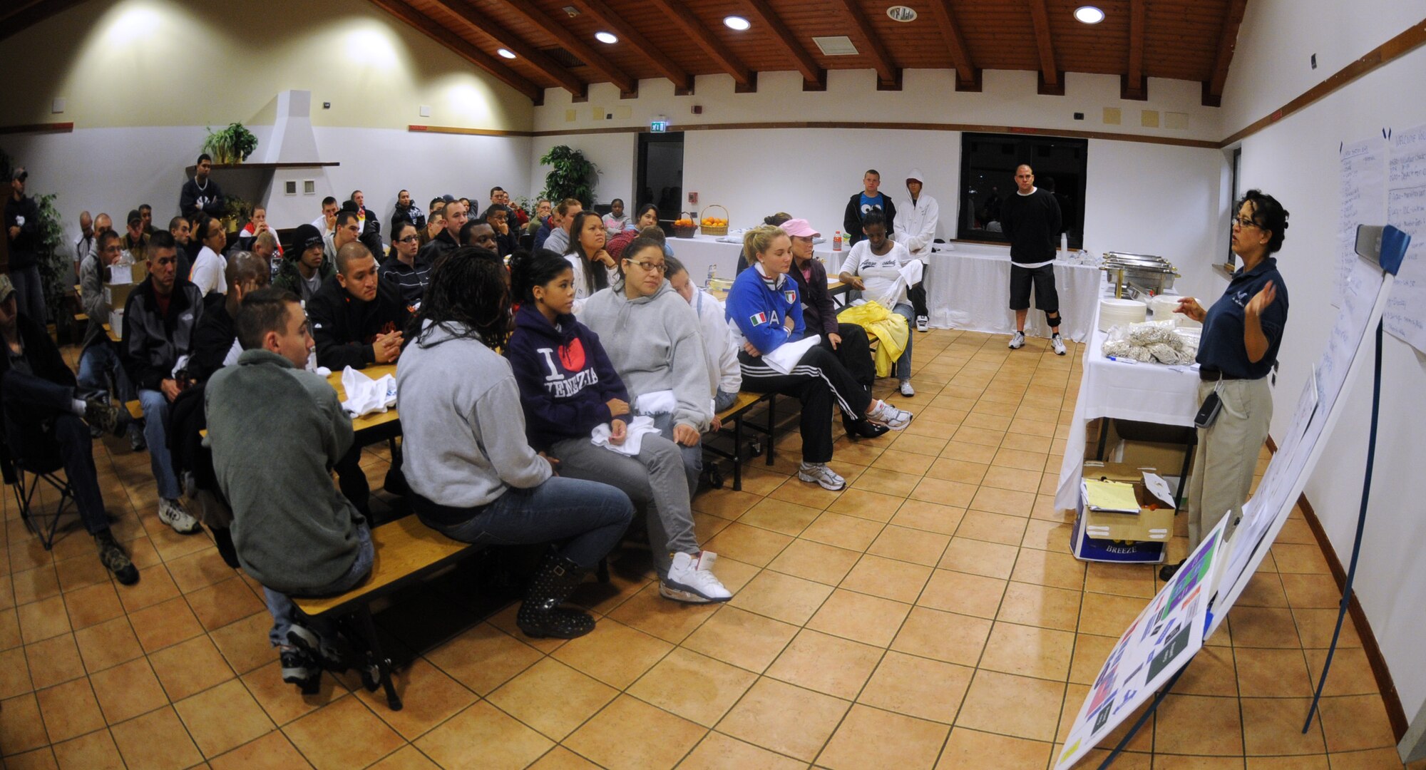 Tanya McCormick, 31st Force Support Squadron fitness center director, briefs the volunteers for the fourth annual Aviano Marathon Sept. 19 at Area D. (U.S. Air Force photo/Staff Sgt. Julius Delos Reyes)