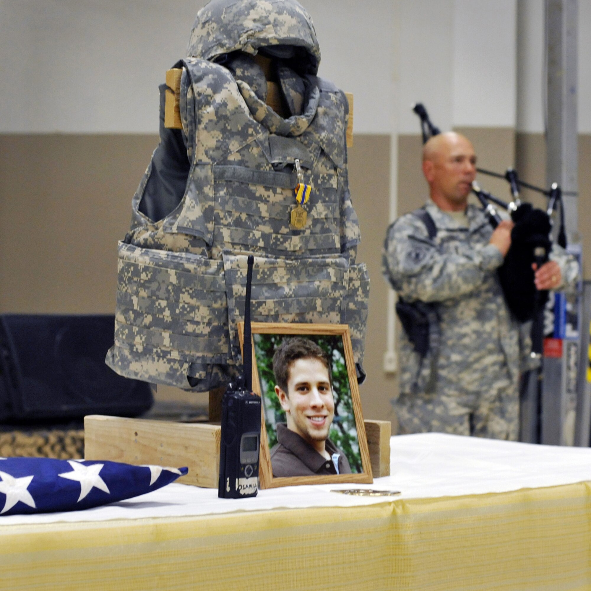 Maj. Peter Schmidt, deputy information management and plans officer with the 103rd Sustainment Command (Expeditionary), plays Taps on bagpipes during a memorial service for Senior Airman James Hansen in a memorial service Sept. 19, 2010 at Joint Base Balad, Iraq.  Airman Hansen, 25, an airfield operations manager assigned to the 332nd Expeditionary Operations Support Squadron, died in an explosive ordnance disposal accident here Sept. 15.  The ceremony included the reading of the citation for the Air Force Commendation Medal for Airman Hansen's exemplary service during his deployment from the 46th Operations Support Squadron, Eglin Air Force Base, Fla., in support of Operation Iraqi Freedom and Operation New Dawn. (U.S. Air Force photo/Lt. Col. Robert Couse-Baker)
