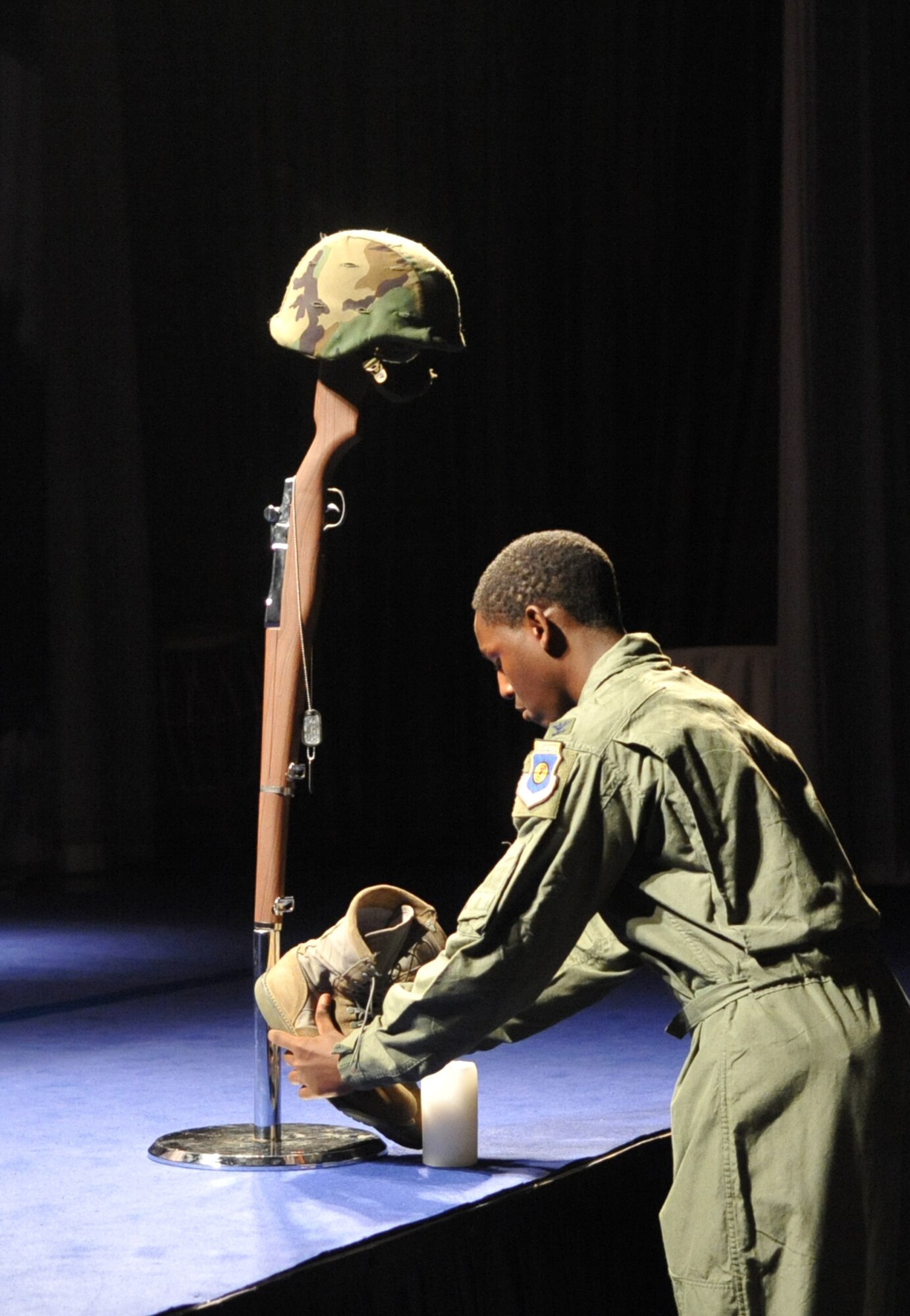 An Airman sets a pair of boots down duiring a remembrance ceremony at the Lotte World Hotel in Seoul, Republic of Korea Sept. 18 for an Air Force Ball celebration. This year marked the 63rd Anniversary of the U.S. Air Force. The birthday celebration included social hour, presentation of colors, dinner, ceremonial cake cutting, and a reception. (U.S. Air Force photo/Senior Airman Evelyn Chavez)