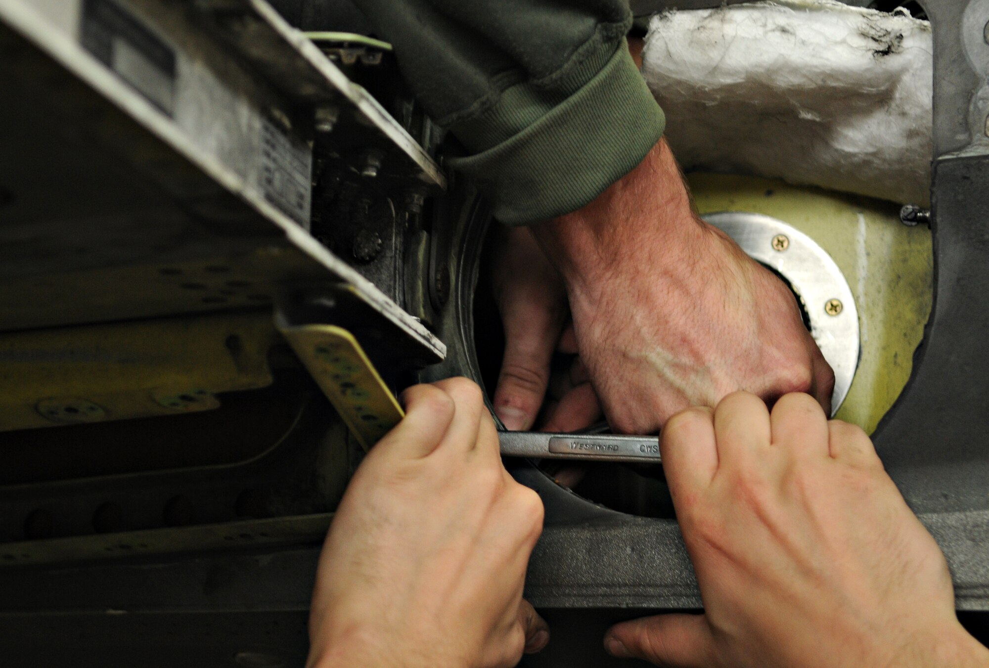 SPANGDAHLEM AIR BASE, Germany – Airmen from the 52nd Component Maintenance Squadron fuel systems repair section fasten nuts and bolts while reattaching the left wing of an F-16 Fighting Falcon Sept. 16. The wing was removed to repair an internal bracket, a process that took more than 85 man-hours. (U.S. Air Force photo/Staff Sgt. Benjamin Wilson)
