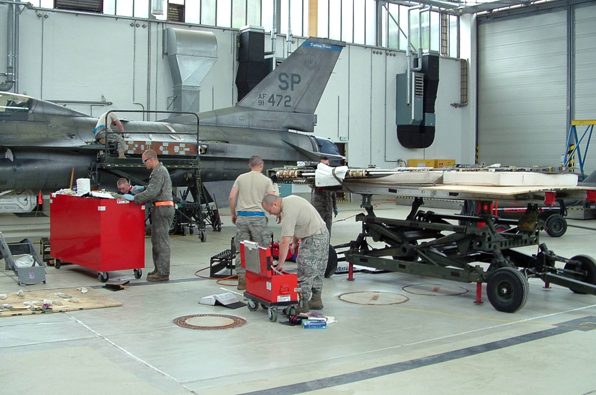 SPANGDAHLEM AIR BASE, Germany – Airmen from the 52nd Component Maintenance Squadron fuel systems repair section replace a damaged bracket in the wing of an F-16 Fighting Falcon Sept. 14. The process of removing and replacing the wing took more than 85 man-hours and has not been done since 2008 on Spangdahlem Air Base. (U.S. Air Force photo)