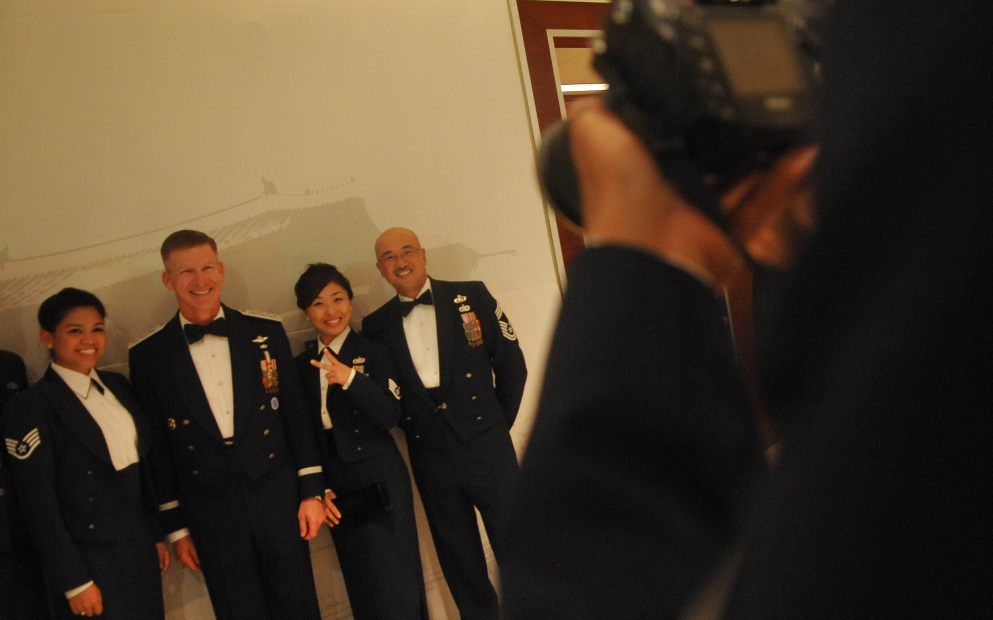 51st Fighter Wing Airmen pose for photos with the 7th Air Force Commander, Lt. Gen. Jeffrey Remington, at the Lotte World Hotel in Seoul, Republic of Korea Sept. 18 for an Air Force Ball celebration. This year marked the 63rd Anniversary of the U.S. Air Force. The birthday celebration included social hour, presentation of colors, dinner, ceremonial cake cutting, and a reception. (U.S. Air Force photo/Senior Airman Evelyn Chavez)