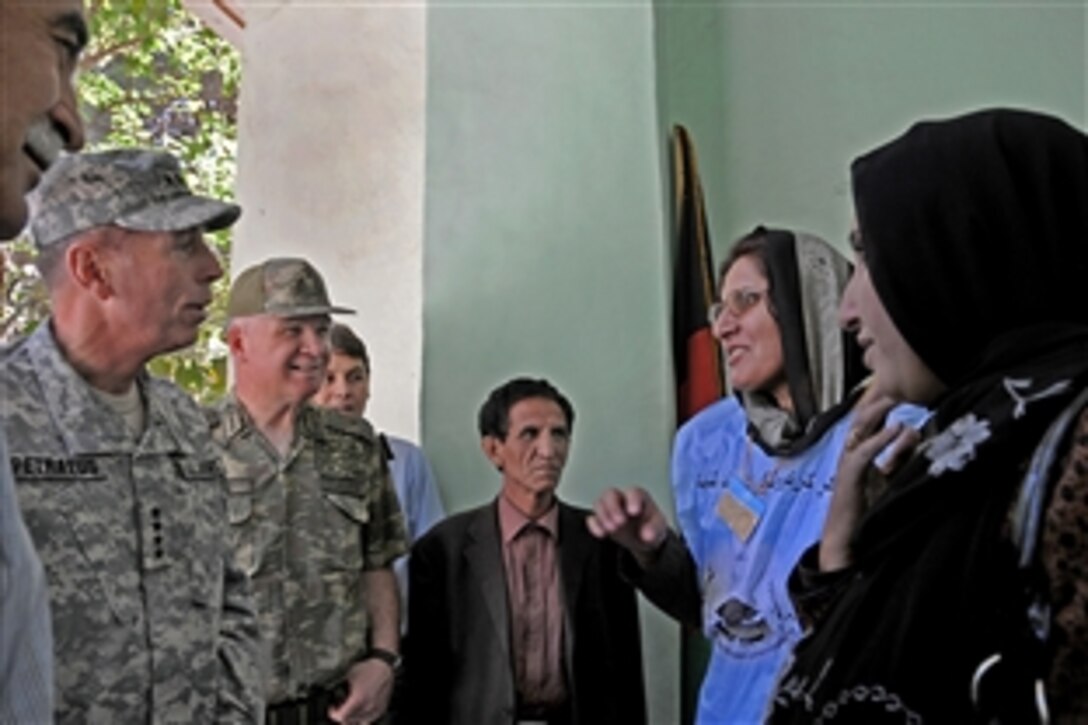 U.S. Army Gen. David H. Petraeus, commander of the International Security Assistance Force in Afghanistan, left, meets the principal of Malalay Girls School, a voting site in Kabul, Sept. 18, 2010. Petraeus toured two of the more than 500 active voting sites in the city on election day.