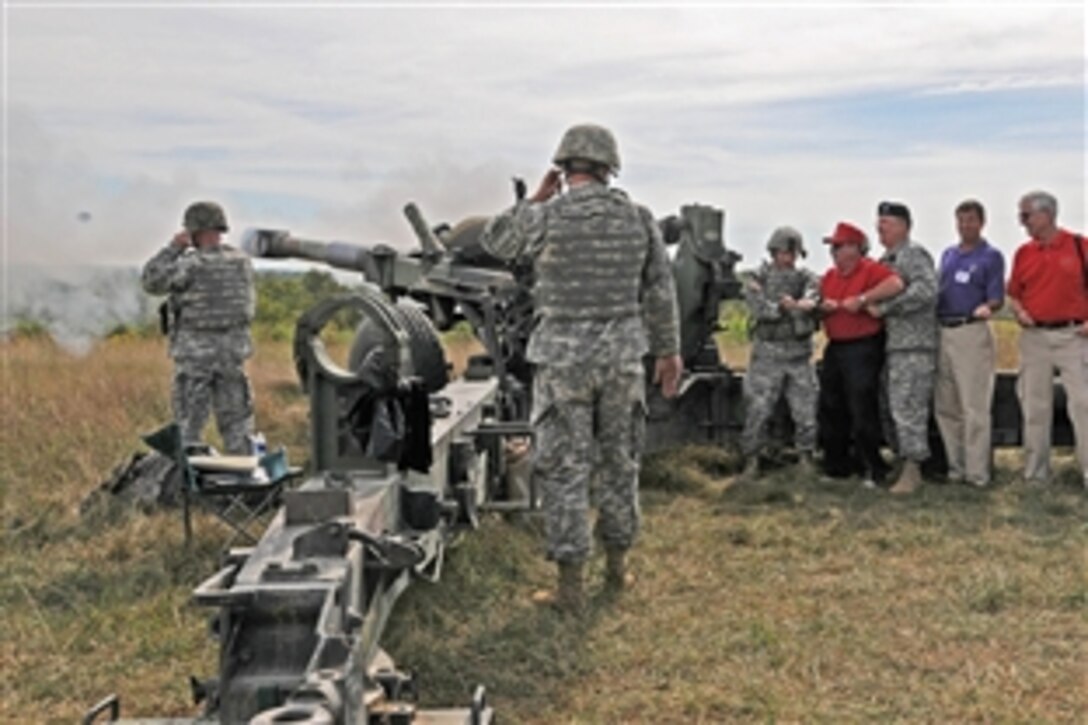 Maj. Gen. Tod Carmony, third from right, commander of the 38th Infantry Division, joins former commanders in yanking  the lanyard to fire the last round for the M198 howitzer during a retirement ceremony for the M198 howitzer on Camp Atterbury Joint Maneuver Training Center, Ind., Sep. 18, 2001. The M198 howitzer is being replaced by the M777 howitzer, which is smaller and approximately 40 percent lighter.