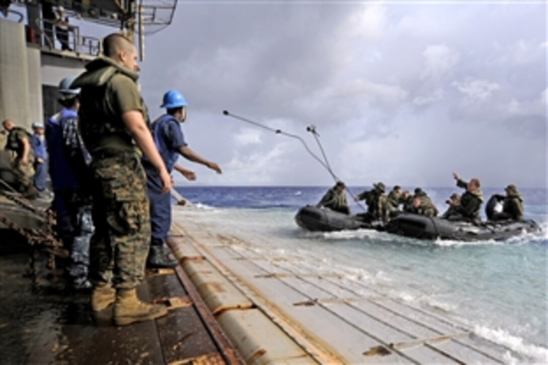 U.S. Marines in combat rubber reconnaissance craft approach the stern gate of the amphibious dock landing ship USS Harpers Ferry in the Philippine Sea, Sept. 19, 2010. The Marines are assigned to the 31st Marine Expeditionary Unit. The Harpers Ferry is on patrol in the western Pacific Ocean and is part of the permanently forward-deployed Essex Amphibious Ready Group participating in Valiant Shield 2010.