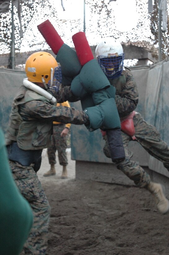 Recruit Michael J. LaCount, Platoon 2103, Company E., 2nd Recruit Training Battalion, uses the wall as leverage to get the upper hand on recruit Gregory Sargent, Platoon 2103, Co. E, 2nd Recruit Training Bn., during their pugil sticks match here, Sept. 21.