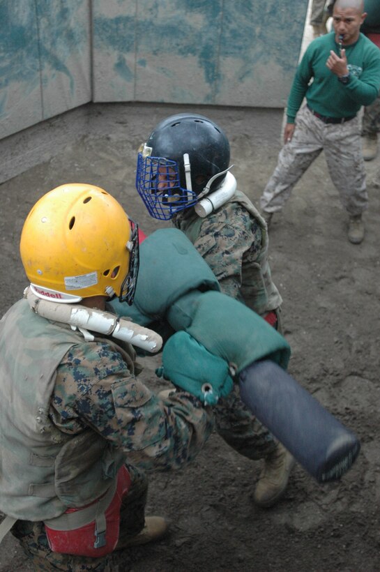 Recruit Joseph Crum, Platoon 2101, Company E, 2nd Recruit Training Battalion and recruit Josh Ingersoll, Platoon 2103, Co. E, 2nd Recruit Training Bn., break away from each other's guard in the center of the pugil sticks III ring here, Sept. 21.