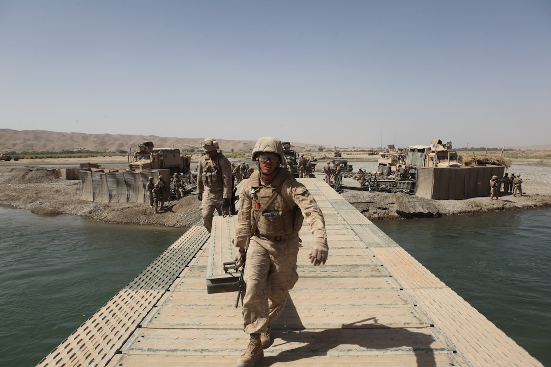 Marines of 9th Engineer Support Battalion (ESB), 1st Marine Logistics Group (Forward), assemble components of a bridge across the Helmand River near the city of Sangin, Helmand province, Afghanistan, September 20, 2010. 9th ESB Marines provide engineering support to coalition forces in support of the International Security Assistance Force.