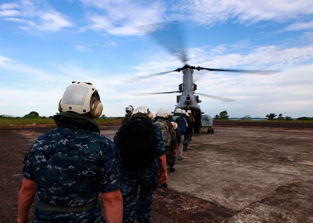 U.S. service members embarked aboard the amphibious assault ship USS Iwo Jima, enter a CH-46E Sea Knight helicopter with Marine Medium Helicopter Squadron 774, to be transported after visiting medical and engineering sites in Bluefields, Nicaragua, Sept. 21. Service members and civilians are deployed in support of Operation Continuing Promise 2010 providing medical, dental, veterinary, engineering assistance and subject-matter exchanges to the Caribbean, Central and South America.