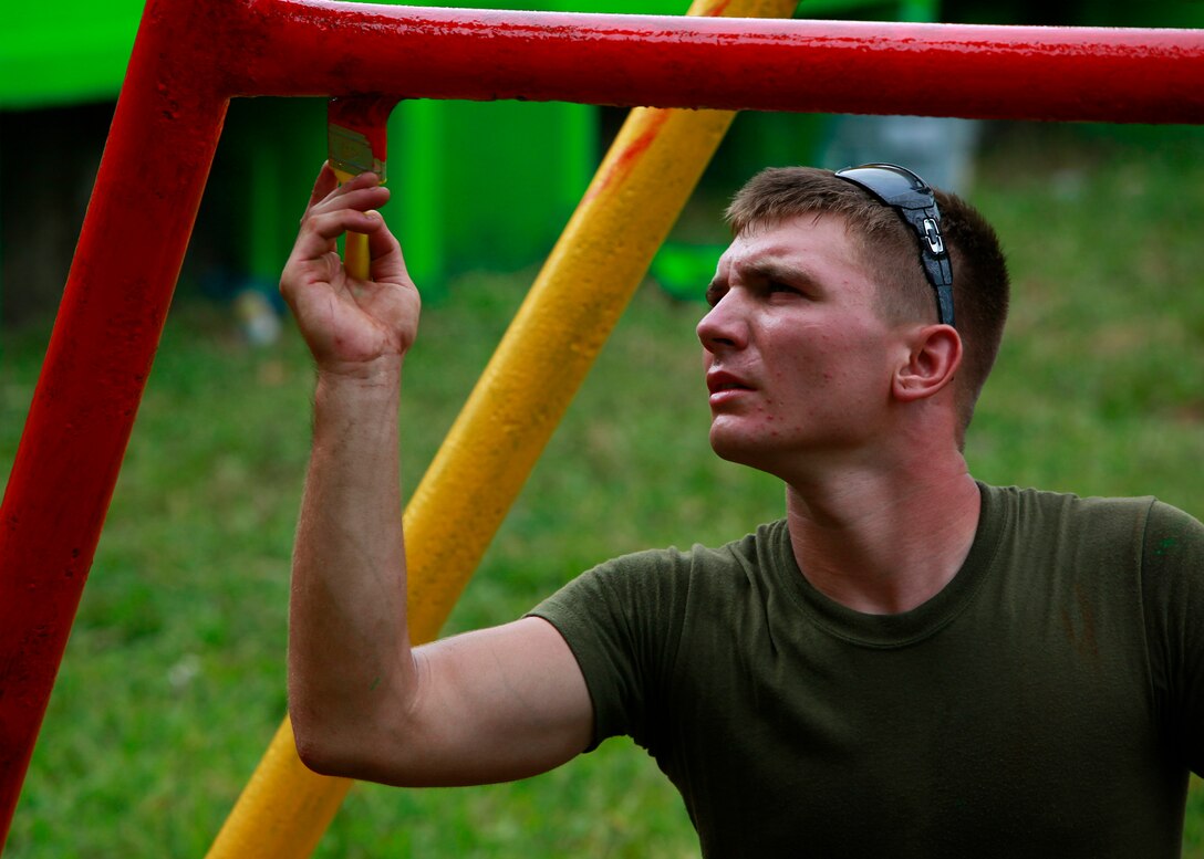 U.S. Marine Pvt. Brent Platukus, a bulk fuel specialist from Exeter, Pa., with Special-Purpose Marine Air-Ground Task Force Continuing Promise 2010, embarked aboard the amphibious assault ship USS Iwo Jima, paints a Nicaraguan swing set at an engineer site in Bluefields, Nicaragua, Sept. 21. Service members and civilians are deployed in support of Operation Continuing Promise 2010 providing medical, dental, veterinary, engineering assistance and subject-matter exchanges to the Caribbean, Central and South America.