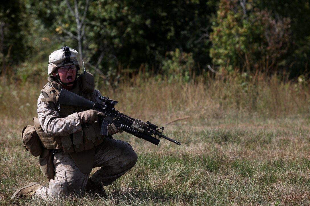 A Marine with 3rd Battalion, 2nd Marine Regiment, yells to another Marine over gun fire and explosions during a training excersise abaord Ft. Pickett, Va., Sept. 21, 2010. The excersise known as the Infantry Platoon Battle Course, features a reinfored infantry platoon attacking an enemy position while supporting elements provide cover fire.
